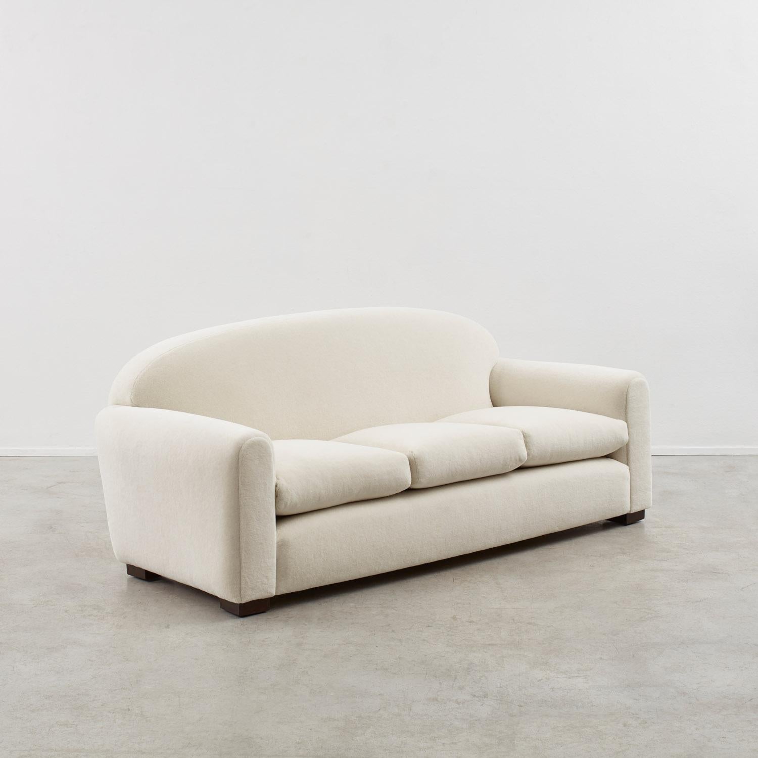 A sloping back, generous cushioning and curved armrests define this French 1930s Art Deco sofa. 

Newly reupholstered in a plush long-pile alpaca and mohair velvet, the sofa is in good condition with some minor wear from age to the feet. 