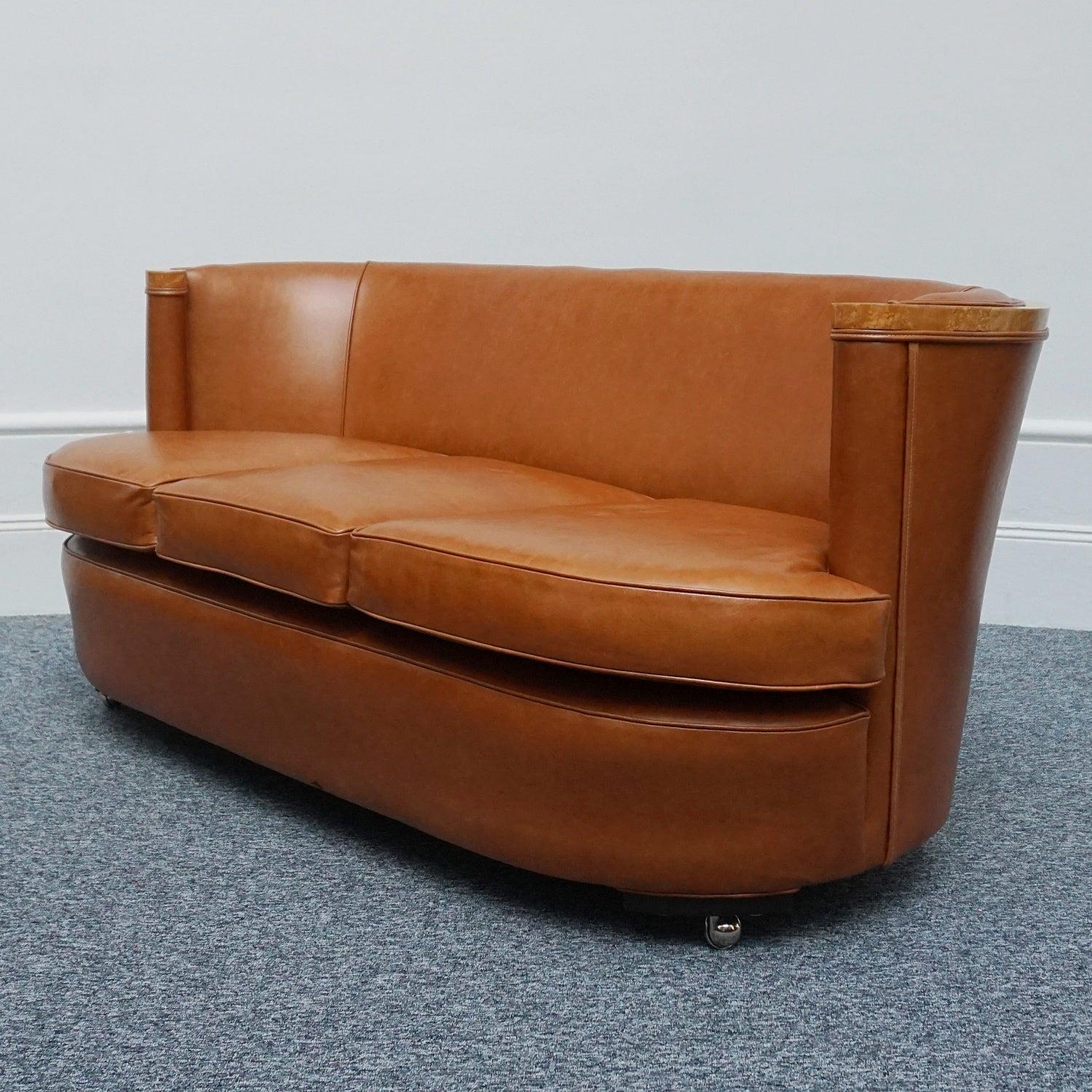 An Art Deco three seater Club Sofa by Maurice Adams with Birdseye maple veneered banding and brown leather re-upholstery. 

Dimensions: H 76cm W 170cm D 93cm Seat H 48cm W 155cm D 65cm. 

Origin: English

Date: Circa 1930

The self