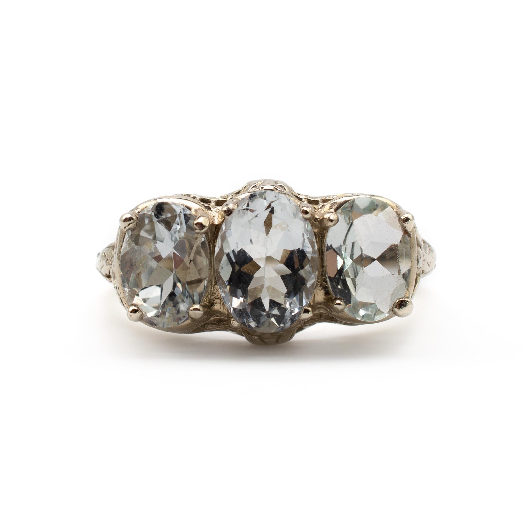 This outstanding Art Deco ring surmounted with 3 oval cut aquamarines totaling approx 3 carats. Made in 14 Karat white gold, the intricate filigree setting compliments the stones nicely.

This genuine Art Deco ring is resented in very clean