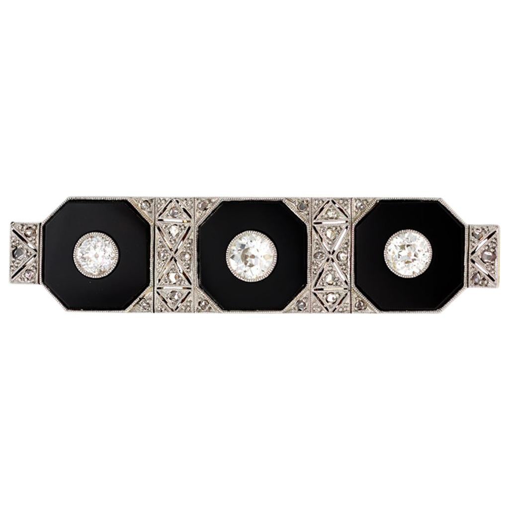 Art Deco Three-Stone Brooch with Diamonds Onyx Set in Platinum and 14 Karat Gold For Sale