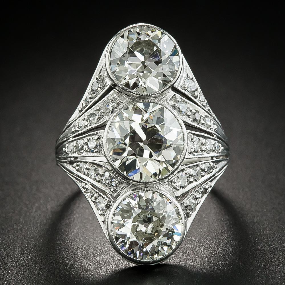 Wear this one on your pointer finger and give directions every chance you get. Wow! A blazing trio of extraordinarily clear European-cut diamonds - together weighing 5.72 carats (the center stone alone weighs 2.50 cts.), sparkle in tandem along with