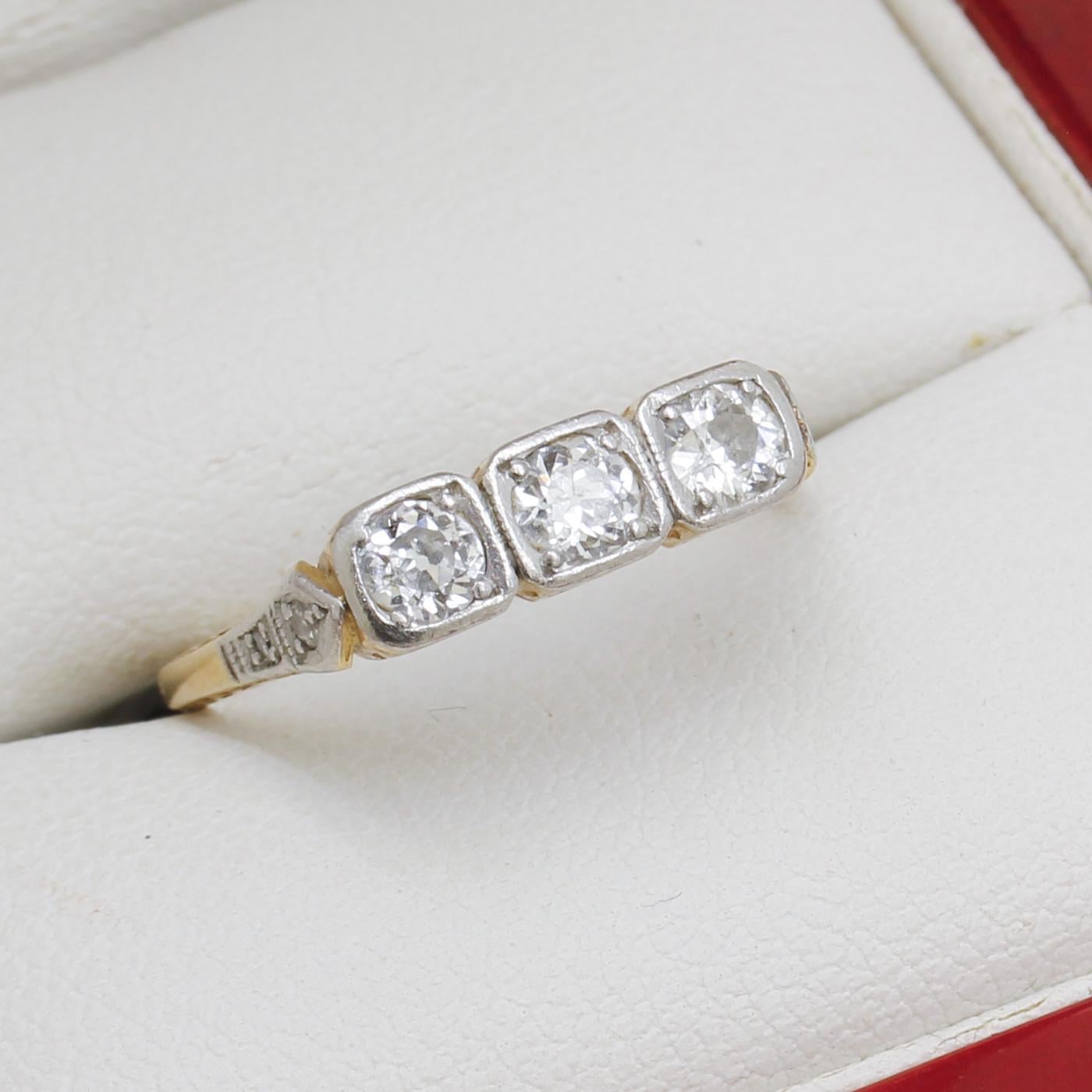 14ct yellow gold and platinum ring, narrow, low half round, tapered shank, with open back, up swept shoulders, polished finish, stamped (PLAT).
The Item Contains:
Three bead set natural old cut diamonds, clarity is 