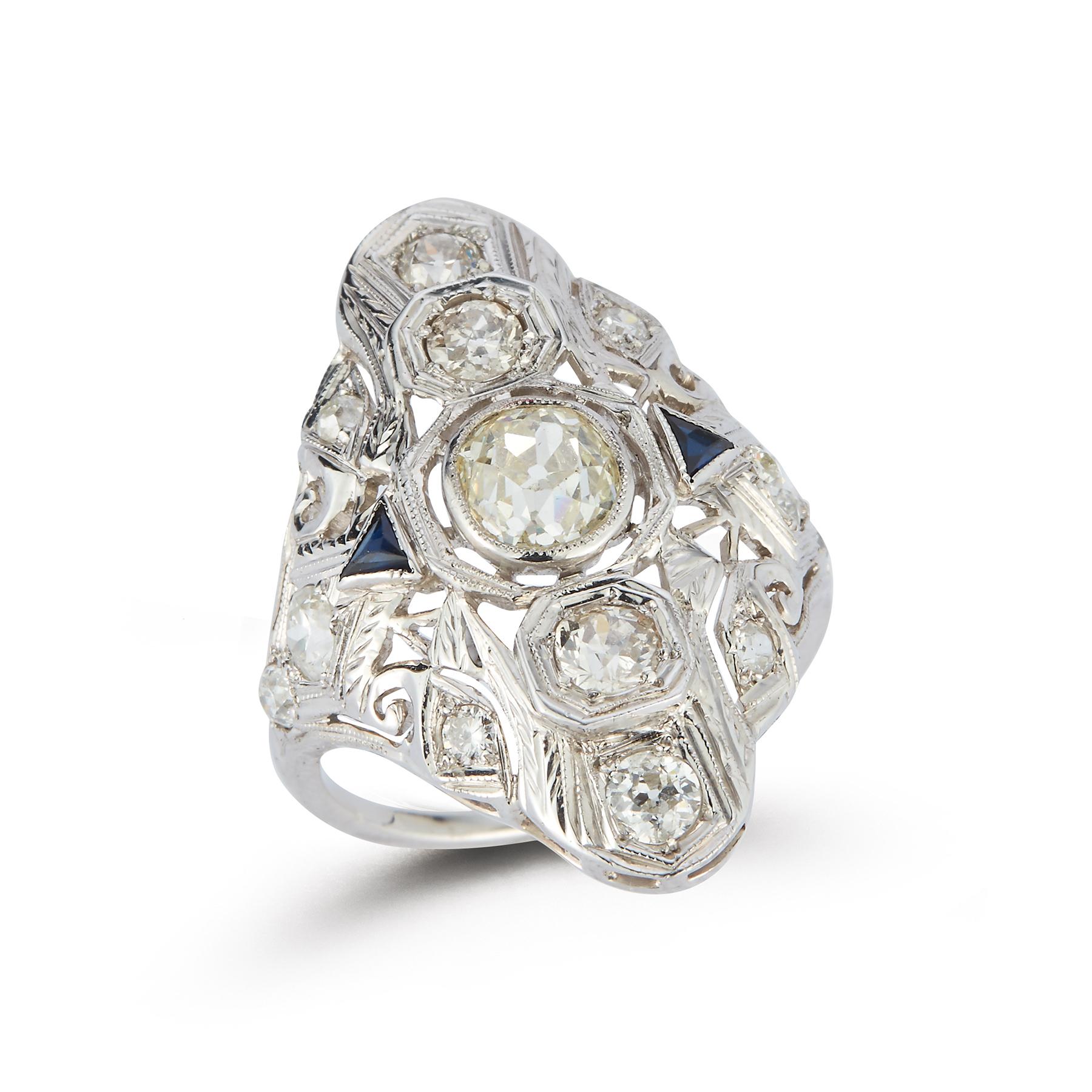 Art Deco Three Stone Diamond Ring
1 Old Mine Diamond approximately  1.07 carats, 12 Old Mine diamonds approximately 1.40 carat, 2 synthetic sapphires all set in 14K white gold 
Ring Size: 6.75
Resizable free of charge 
