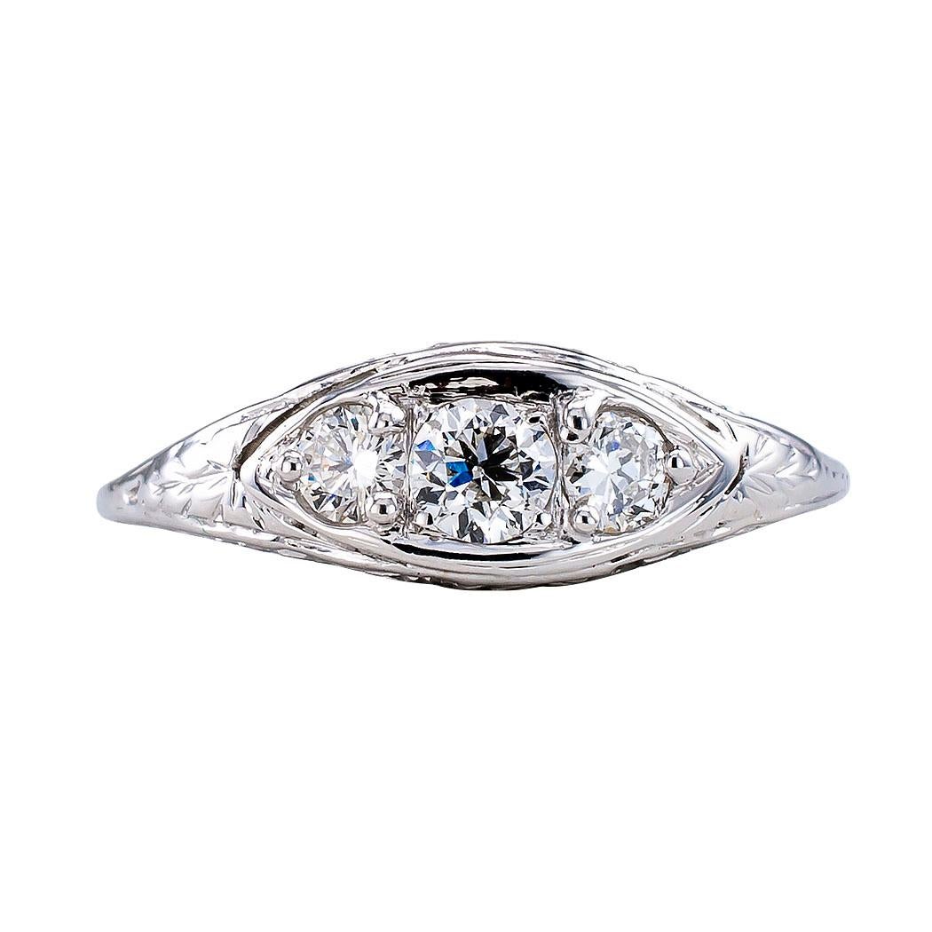 Art Deco three stone diamond and gold ring circa 1930. Set across the top with three round diamonds totaling approximately 0.45 carat, approximately H – I color and SI clarity, within a navette-shaped border to the tapering shank and shoulders
