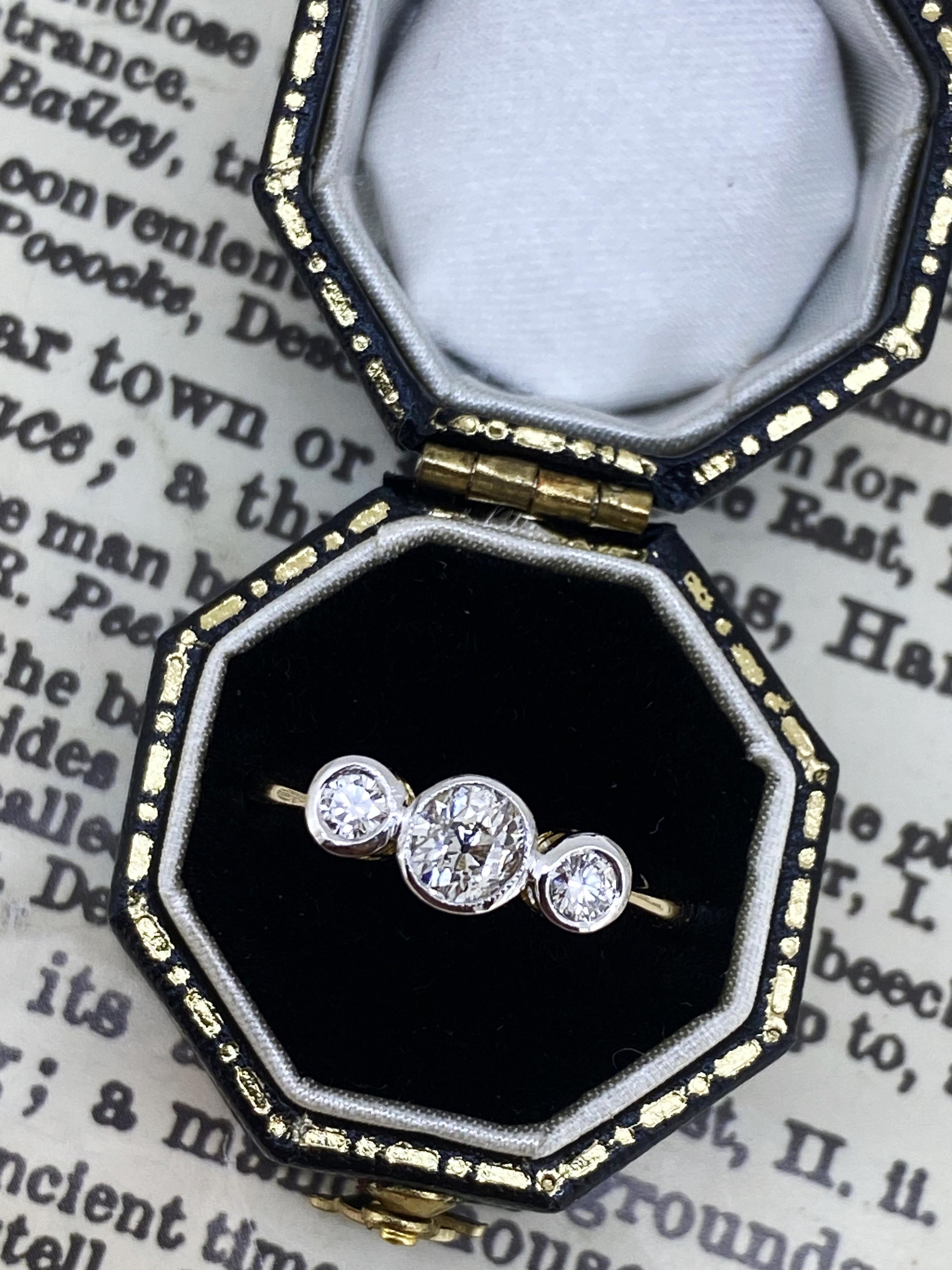 This visually striking Art-Deco piece of jewellery is
is crafted in 18K Yellow Gold & Platinum 
with remarkable attention to details:

Designed as a 3-stone ring with:  
Center stone: old-European cut diamond – 
which is rare & sought after