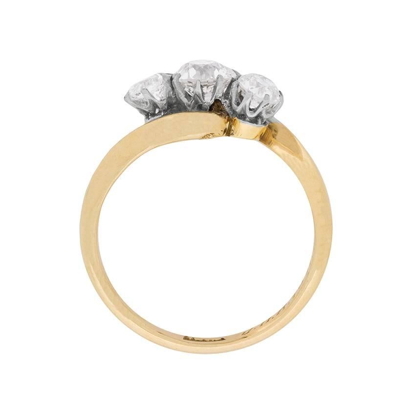 This gorgeous little three stone twist ring dates back to approximately 1918, which is engraved just inside the band. There is a total weight of 1.00 carat, and the diamonds are old cuts.

The antique ring would have been hand crafted and the