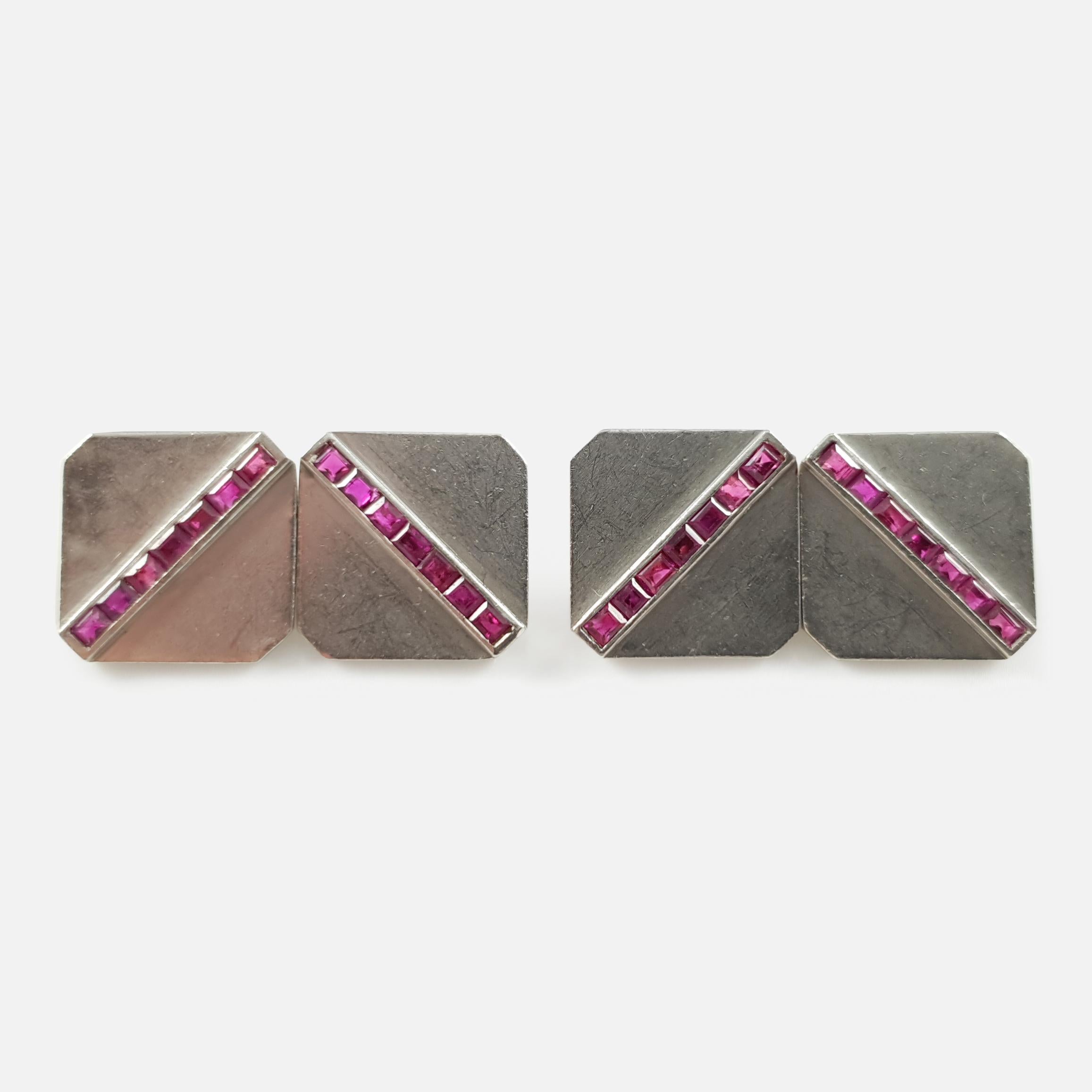 A pair of vintage ruby cufflinks, by Tiffany & Co. The cufflinks are double-sided, each octagonal panel is set with a diagonal row of baguette-cut rubies, with chain-link connectors.  The chain-link connectors are stamped '14' to denote 14 karat
