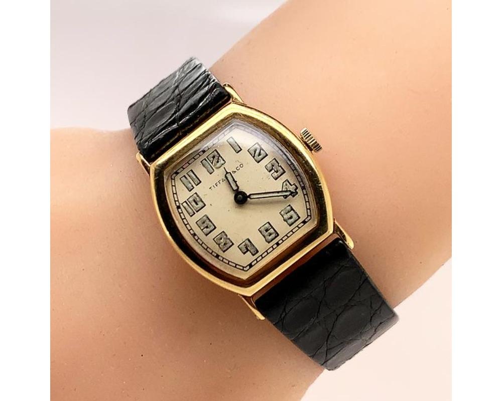 14K Y/g lady's wrist watch mechenical with I.W.C. watch movement, Tiffany watch band. measures 1 x 1 inch
