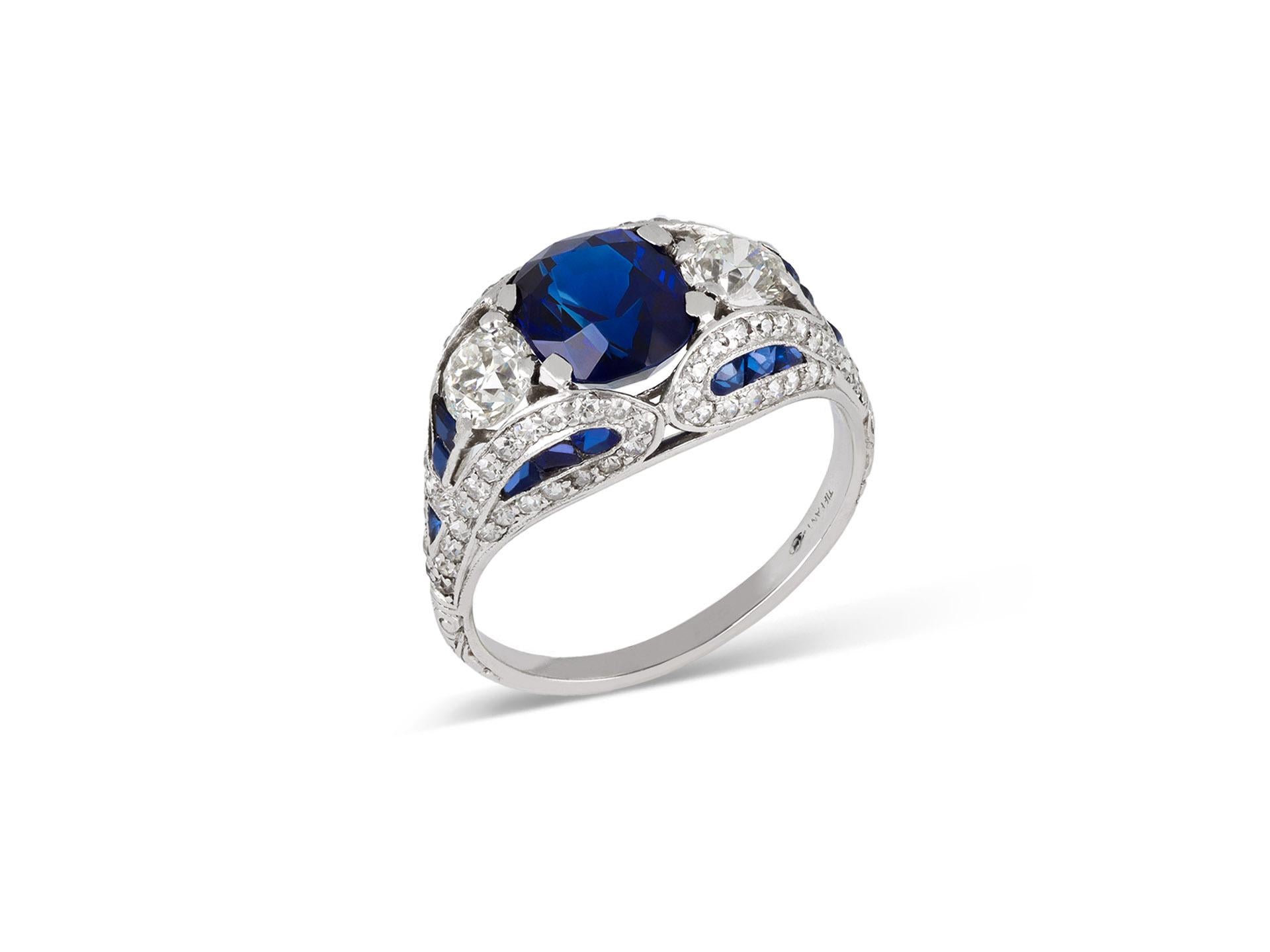 Art Deco Tiffany & Co. sapphire and diamond cluster ring. Set to centre with a cushion shape mixed cut natural unenhanced sapphire in an open back claw setting with an approximate weight of 2.00 carats, flanked by two round old cut diamonds in open