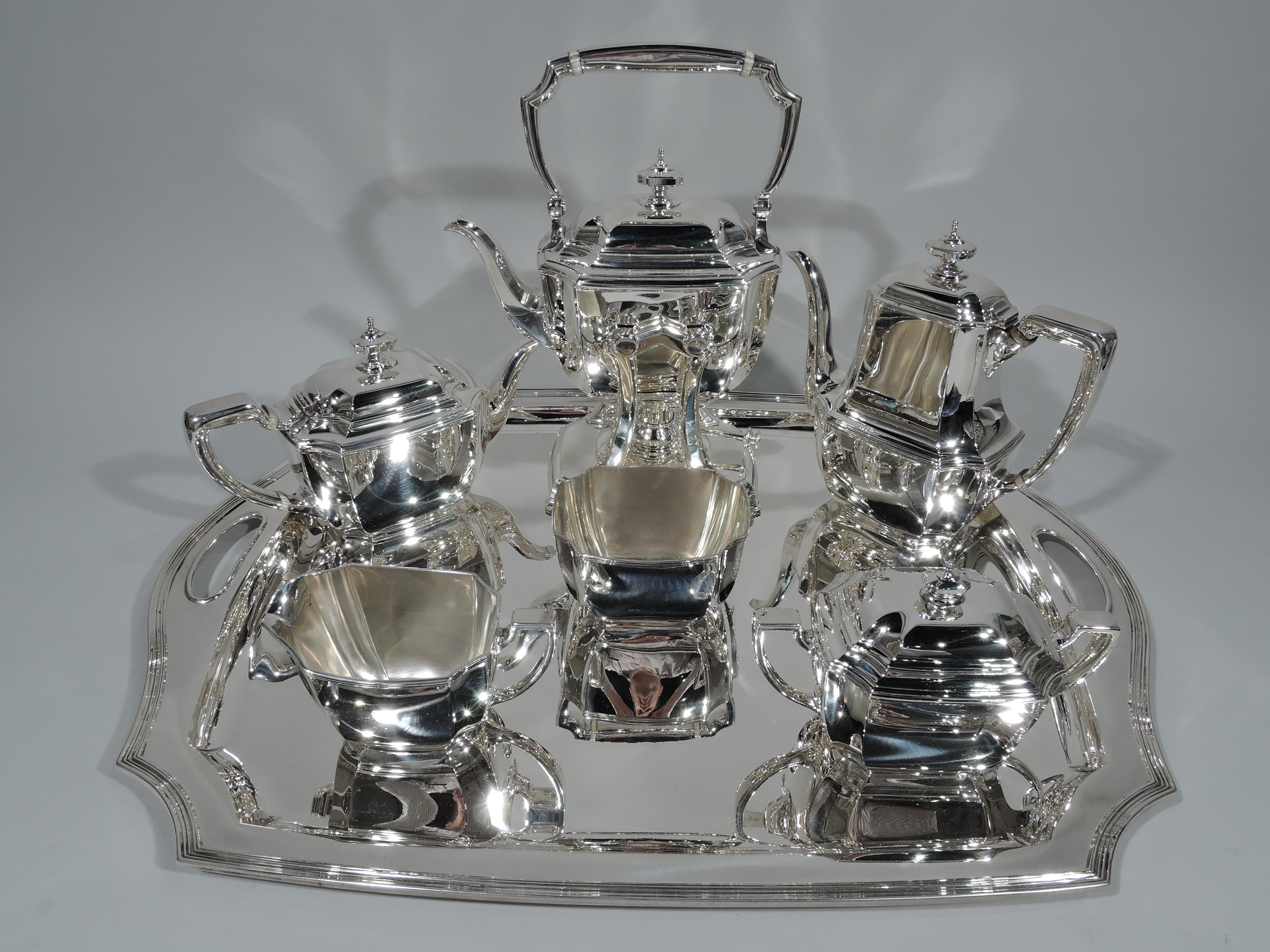 Art Deco sterling silver coffee and tea set on tray in classic Hampton pattern. Made by Tiffany & Co. in New York, circa 1920. This set comprises hot water kettle on stand, coffeepot, teapot, creamer, sugar, and waste bowl on tray.

All: