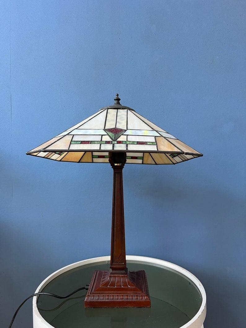 Large Tiffany style desk lamp with colourful stained glass shade. The base is made out of metal and the shade is made from acrylic. The stained glass creates a beautiful light effect. The shade can be taken off the base and positioned in any way