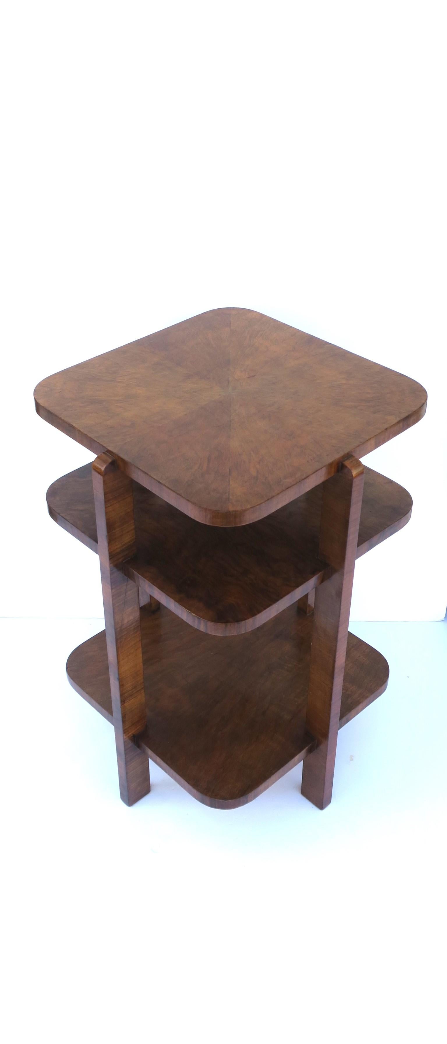 A rich tiger maple wood veneered wood drinks/side/end table with shelves, in the Art Deco style, circa mid-20th century, Europe. In addition to table's top, table has two shelves that can hold or display items as shown. Table is a nice size, not too
