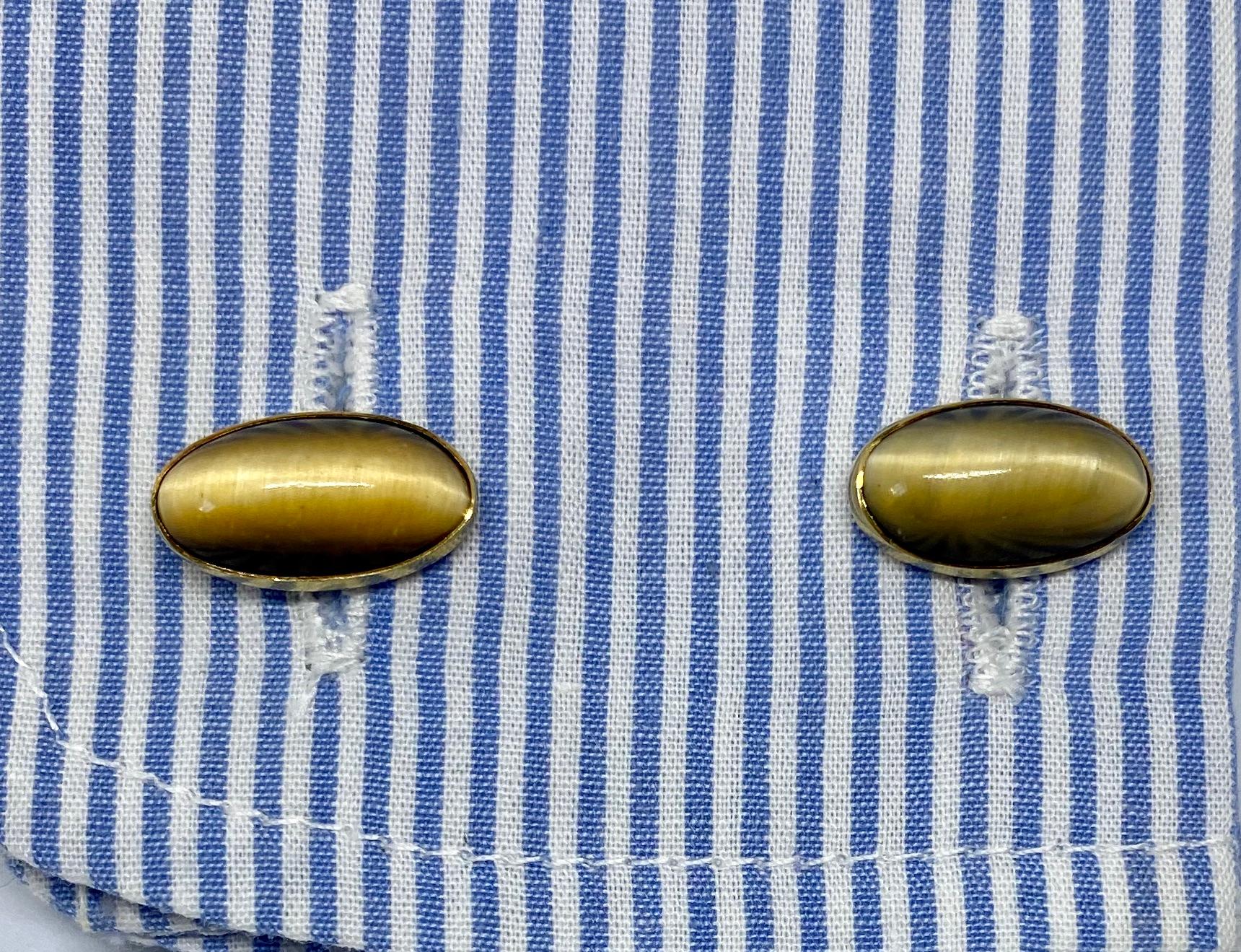 Truly exceptional, double-sided cufflinks by prominent American maker Sansbury & Nellis featuring four oblong tiger's eye cabochons set in 14K yellow gold. They're signed with the S-N maker's mark and 14K.

American cufflinks from the early 1900s