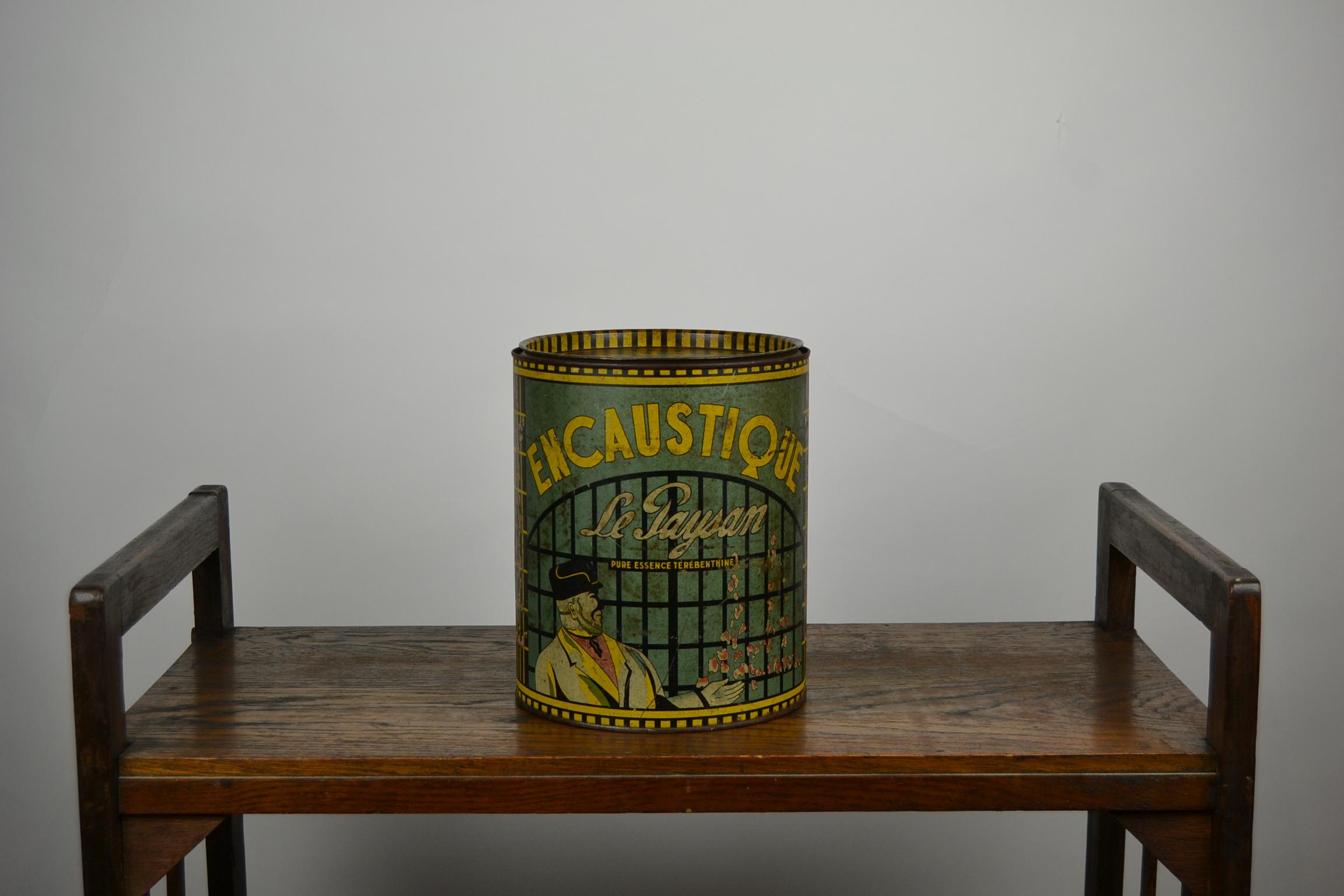 Art Deco tin box for Encaustique Le Paysan,
a French product for cleaning and restoring furniture, marbles, leather, parquet.
This round Tin has a beautiful lithographic design and lettering.
It was made by G. Dupain – Rouen, France between 1920