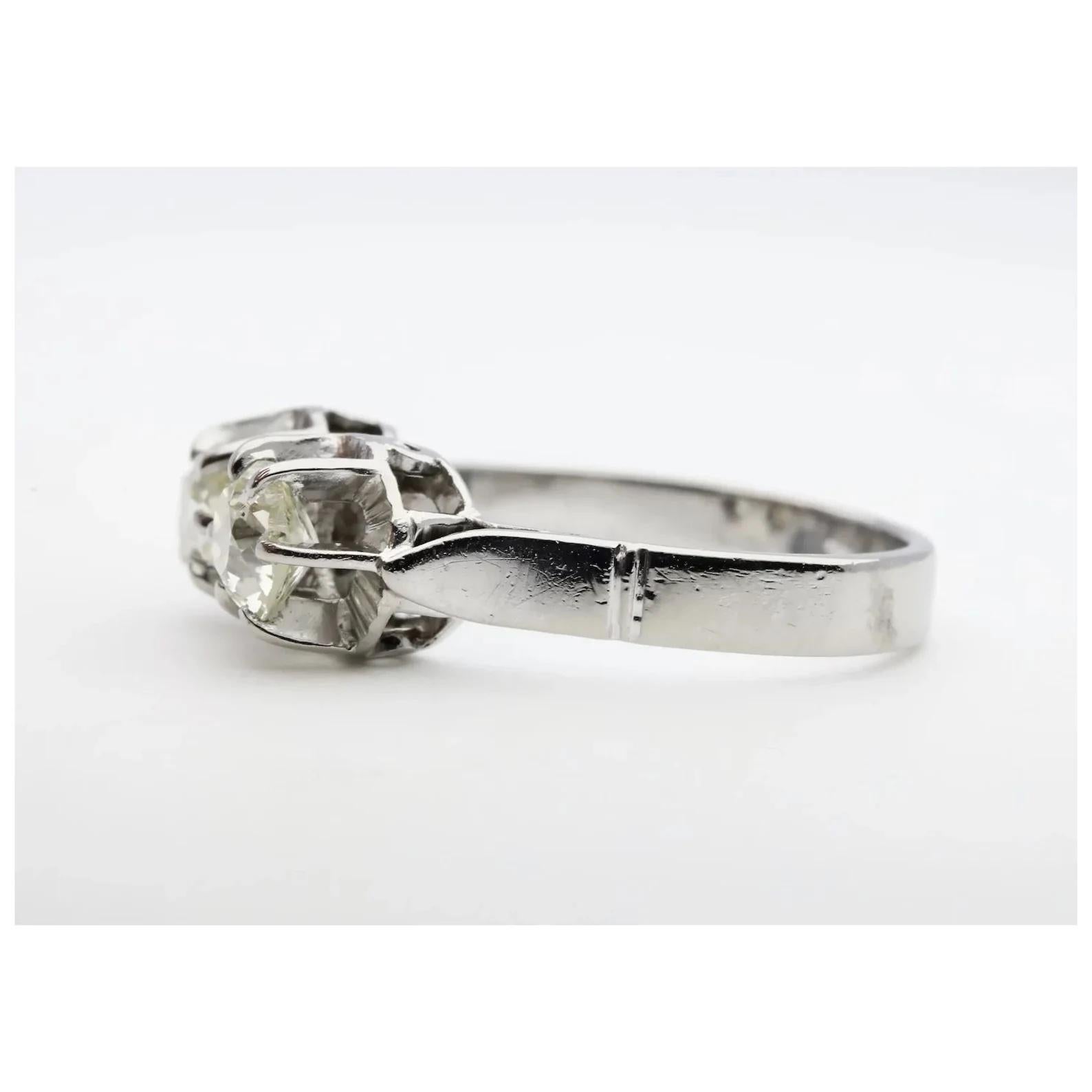 An original Art Deco period Toi et Moi diamond ring in 18 karat white gold. This ring features two sparkling antique old mine cut cushion shaped diamonds set in hand crafted buttercup style six prong mountings. The larger diamond weighs 0.65 carats,