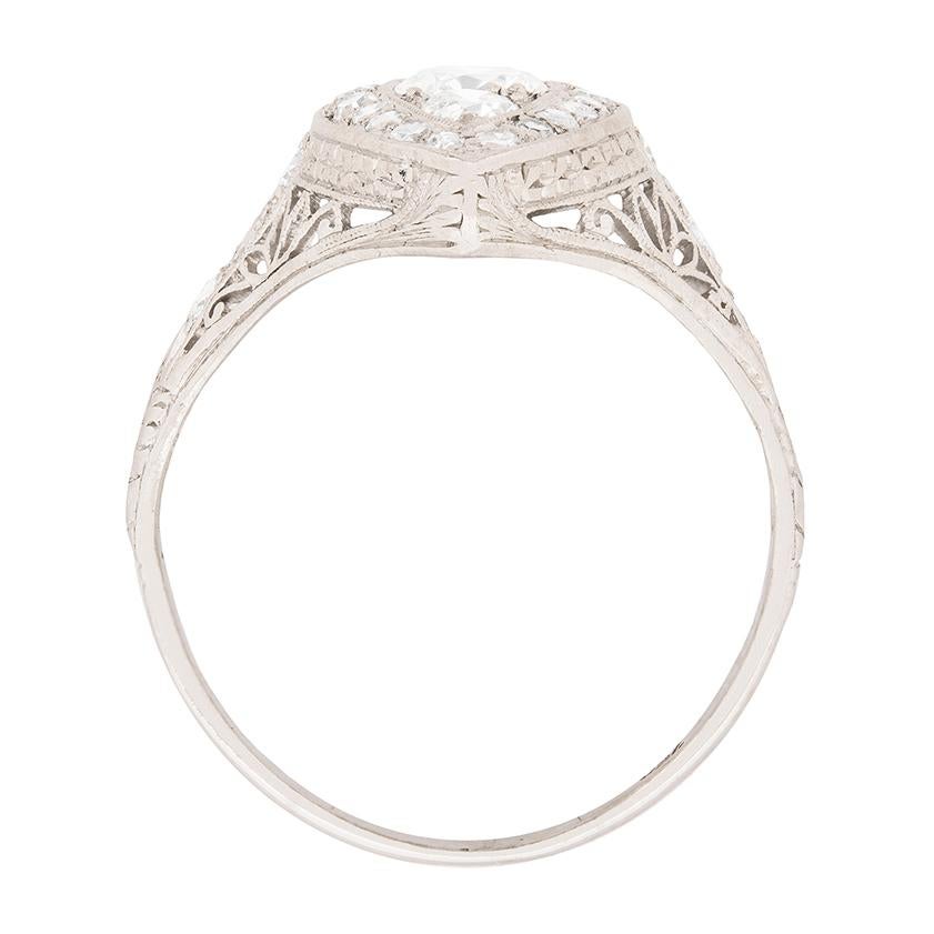This handmade cluster ring dates to the 1920s and is made up of transitional cut diamonds and 8-cut diamonds. The centre three stones are the transitional cut diamonds, with the centre weighing 0.40 carat and the two adjacent each weighing 0.15