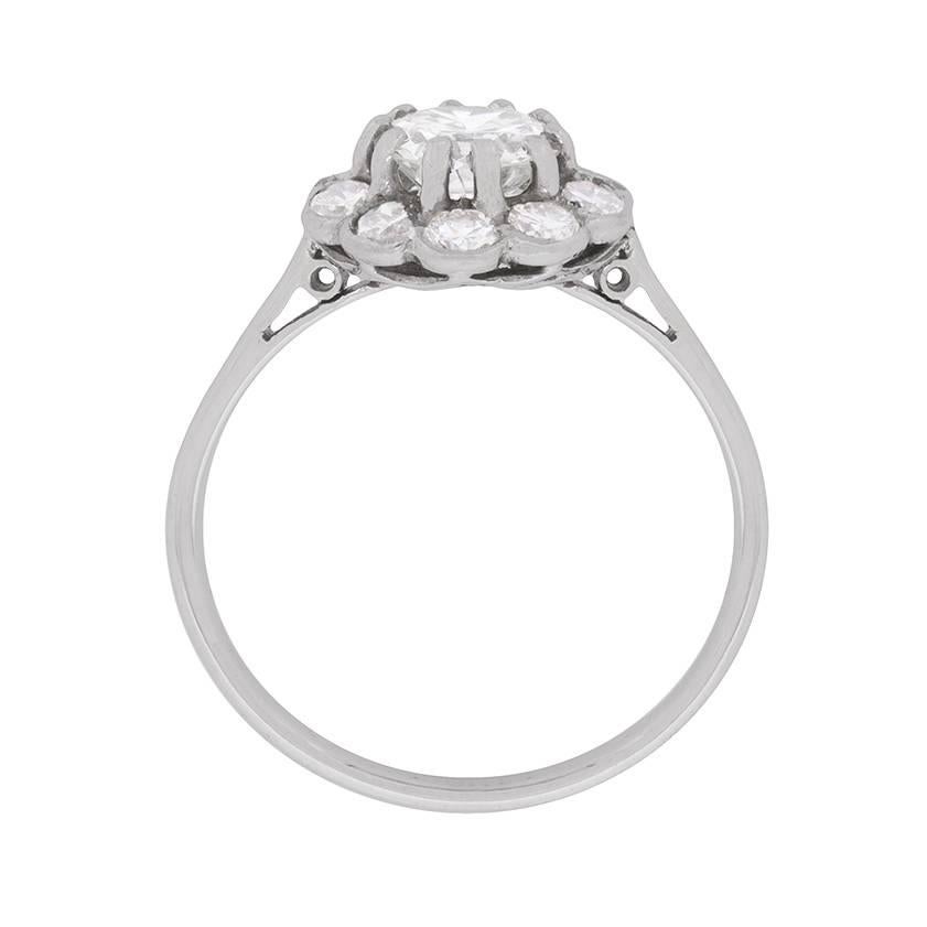 This decadent diamond ring has a centre transitional cut stone weighing 0.90 carat, which is then beautifully surrounded by a halo of diamonds. The halo has a combined weight of 0.50 carat and they are expertly rub over set. The centre stone is in a