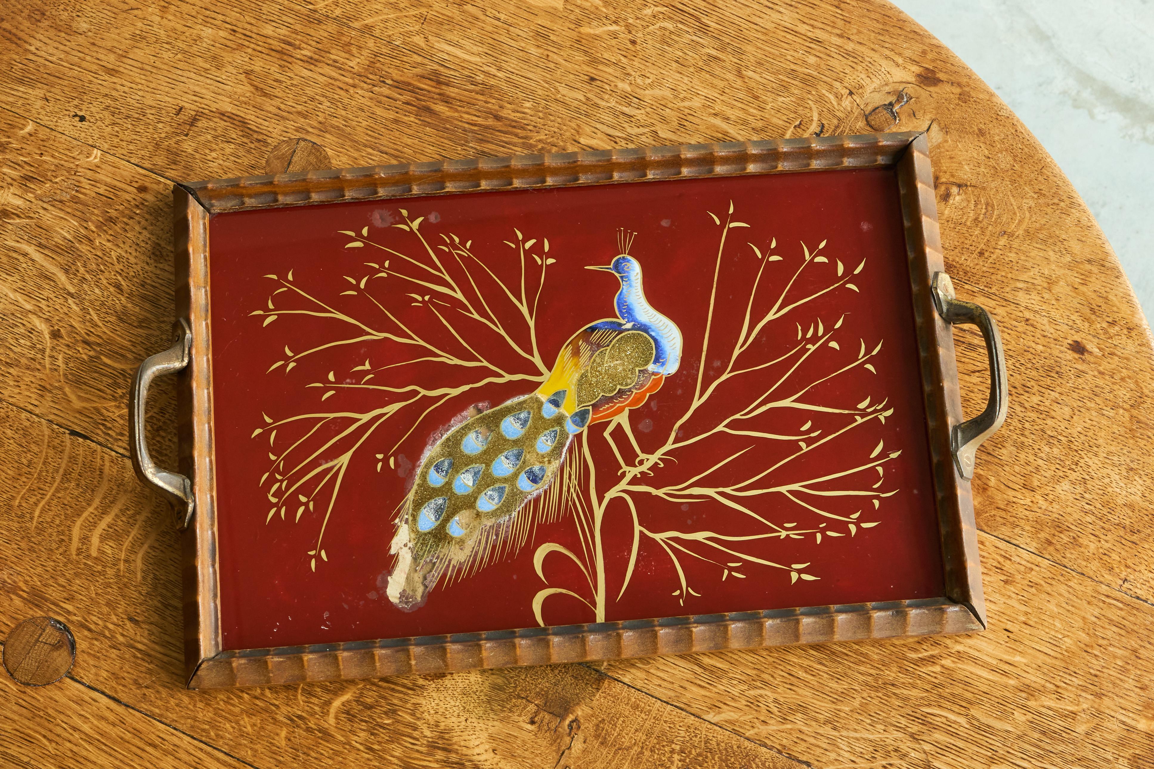 Art Deco Tray in Verre Églomisé, Wood and Brass with Peacock, Europe, early to mid 20th century.

This is a truly wonderful art deco tray with a very nice peacock design in verre églomisé. Very elegant and distinct art deco design with nice colors