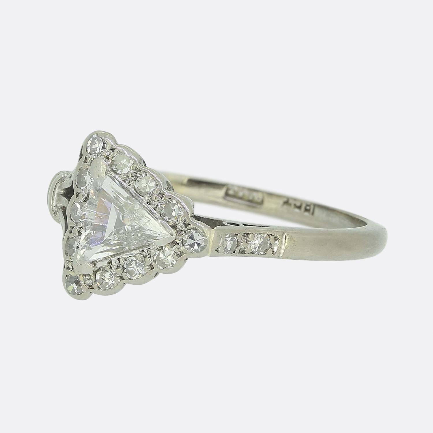 Here we have a gorgeous diamond ring taken from the Art Deco era. This piece has been crafted from both 18ct gold and platinum and features an excellently hand cut triangular shaped diamond at the centre of face. This bright white stone sits