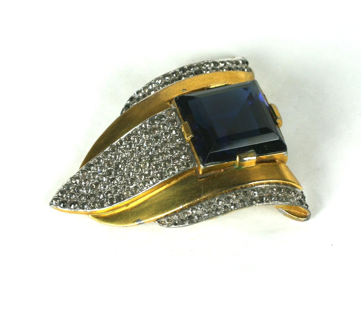 Large Art Deco Trifari Sapphire Clip from the 1930's by Alfred Phillipe. Large faux square cut sapphire with pave accents on gilt metal. Perfect for a neckline or lapel.
1930's USA.  1.75