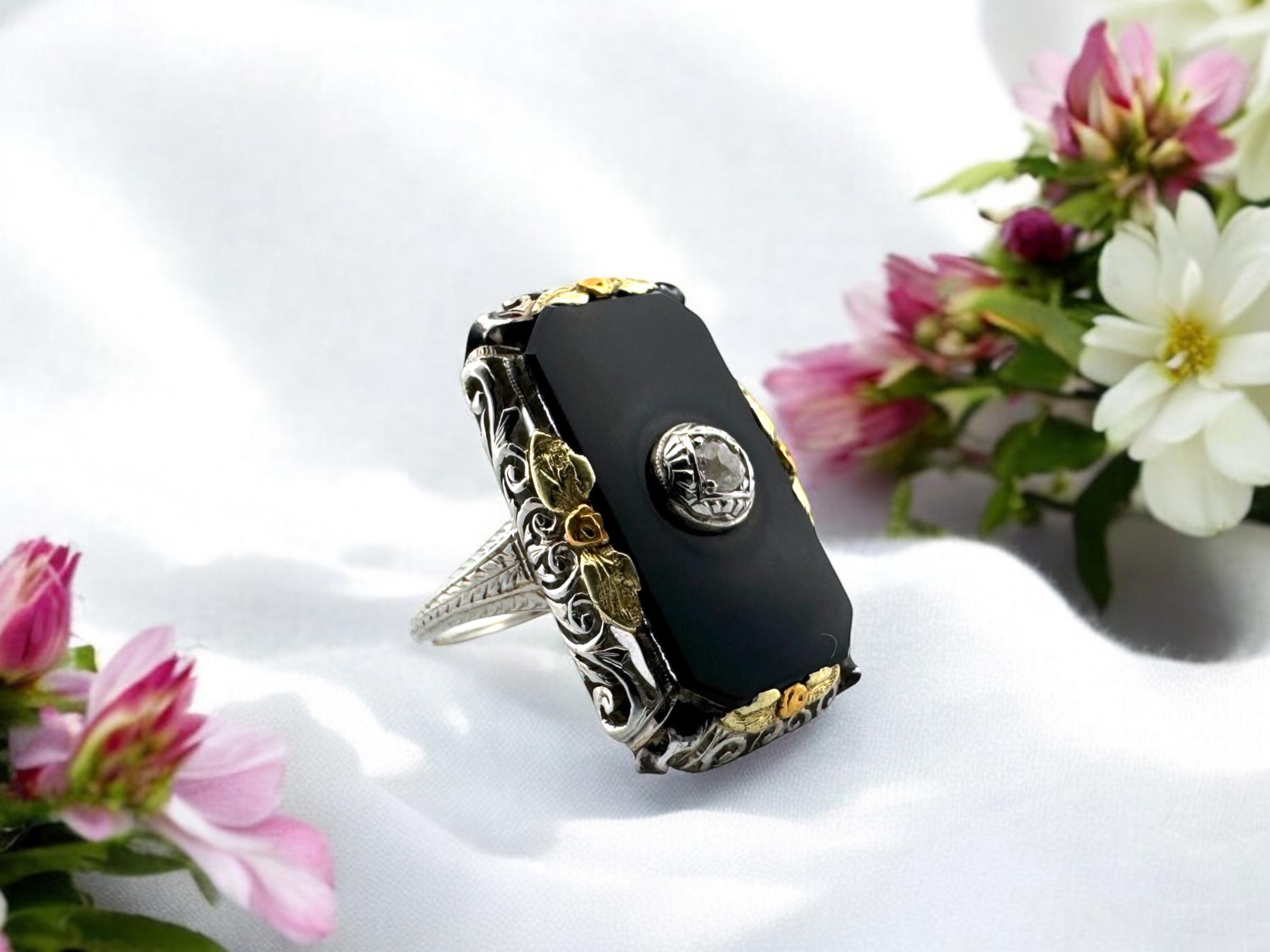 This beauty must be seen to truly appreciate!
She is elaborately detailed with three different gold tones; white base with green and rose gold floral accents.

Ring Details
Material: 18K White Gold
Era: Art Deco 1920 - 1940
Head Length: 1 Inch
Head