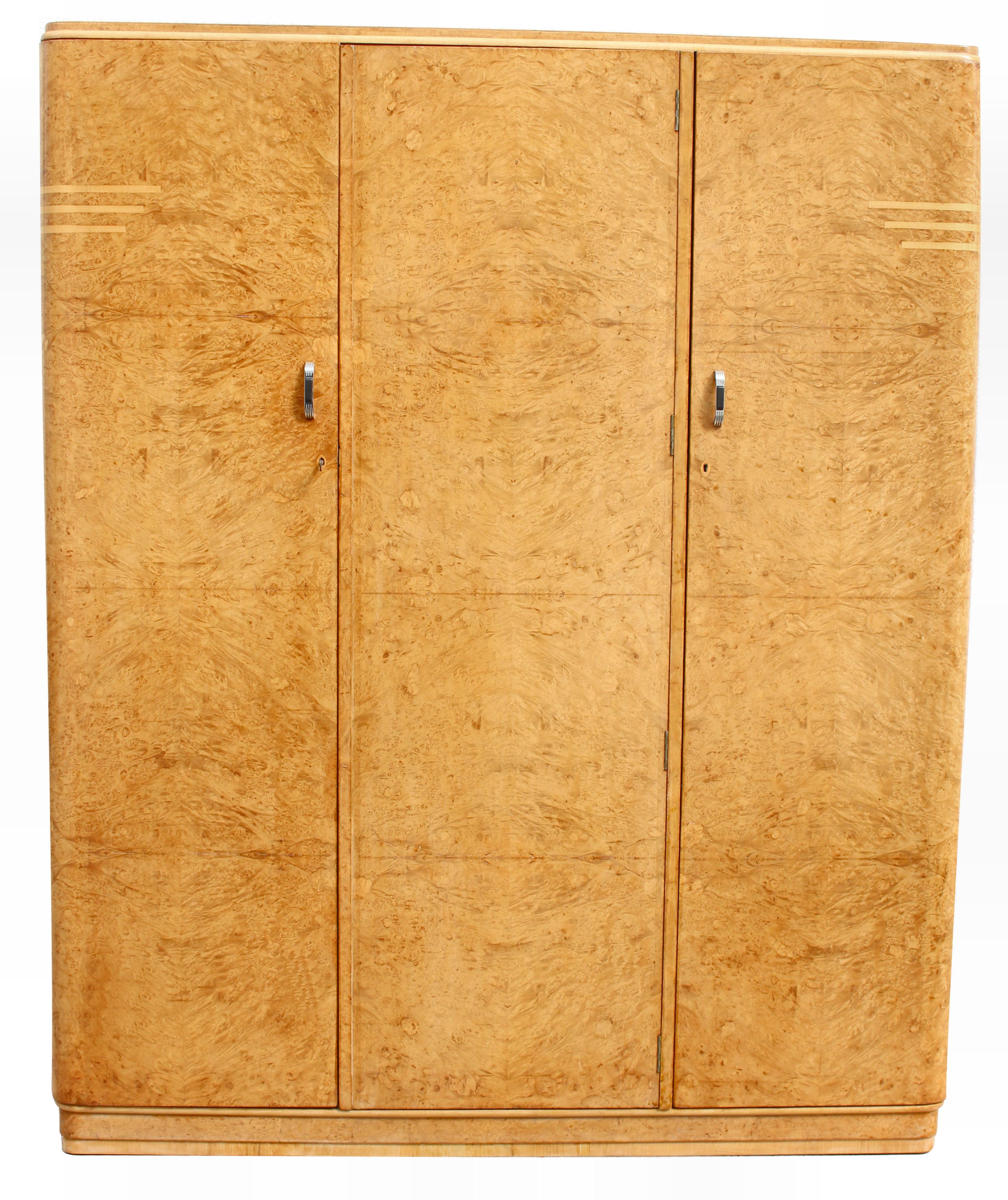 For your consideration is this very high quality Art Deco blonde birds eye maple triple wardrobe with pale blonde satin accenting banding . Made in the 1930's and originating from England this beautiful wardrobe exudes quality and style and offers a