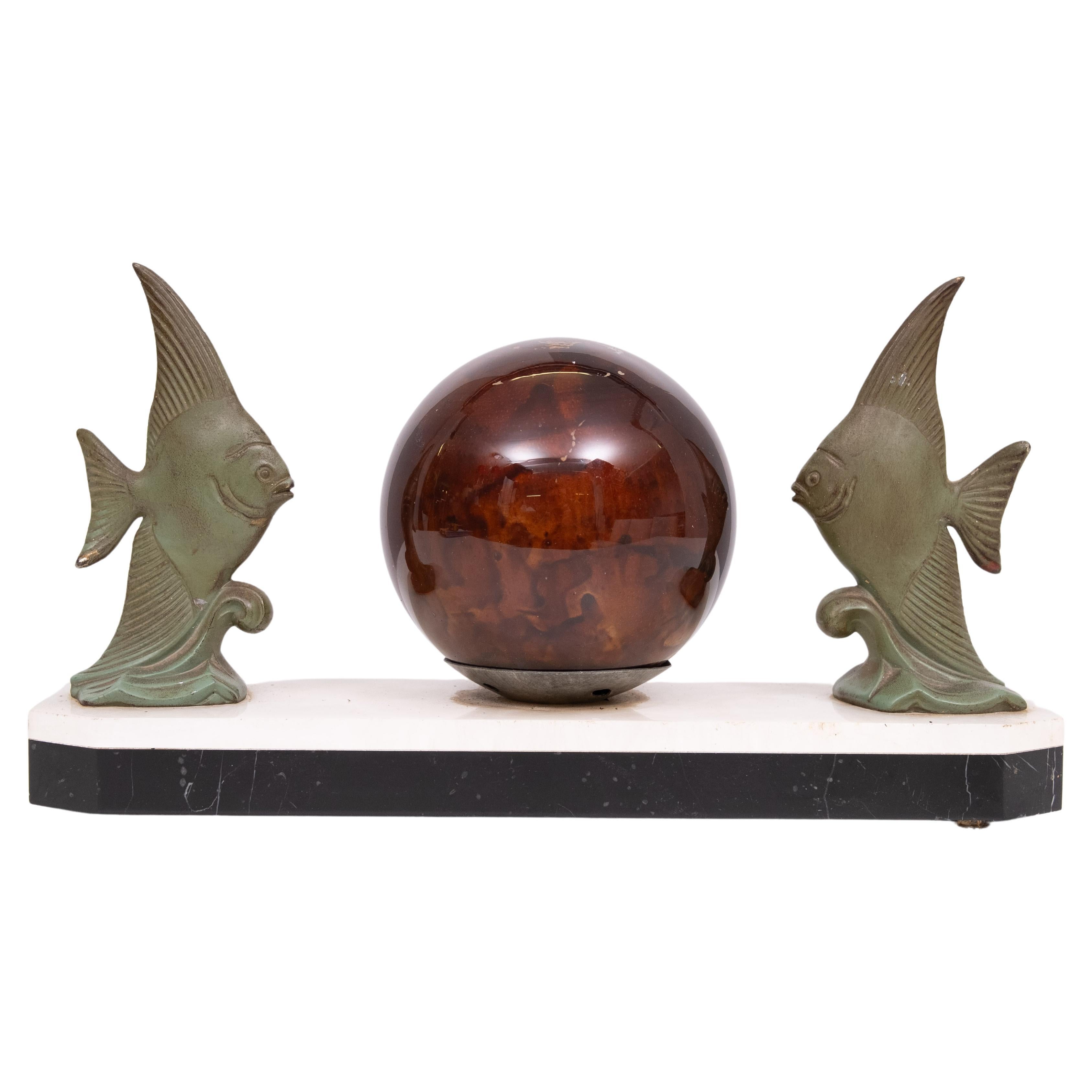 
Art Deco patinated, green bronze tropical fish lamp. A bronze fish swimming towards an original crackle glazed glass sphere. Original marble base. Re-wired  . Included 7 Watt bulb . 
 