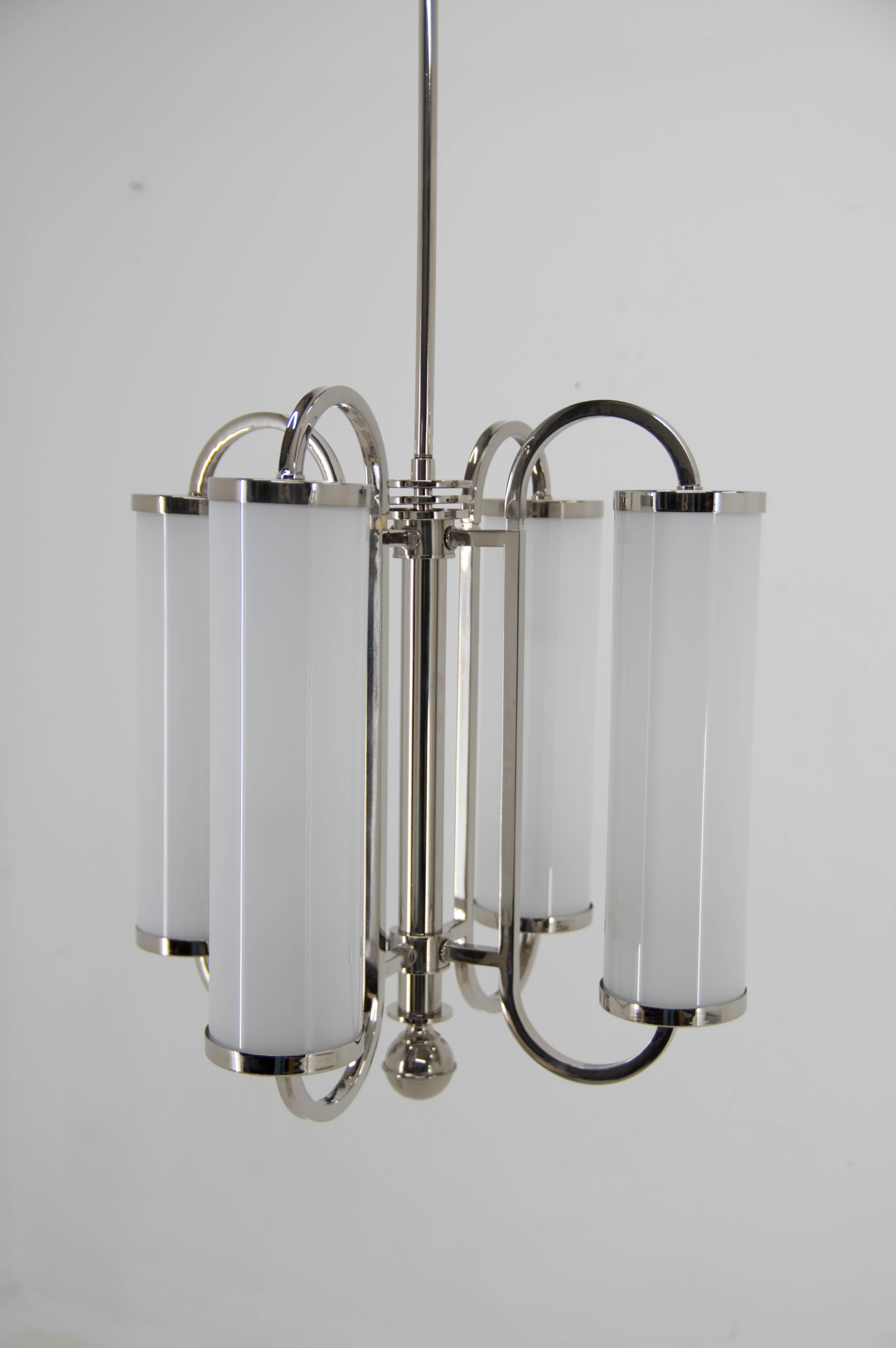 Rare 4-flamming Art Deco tubular chandelier. 
Professionally restored: new nickel-plating.
Blown opaline glass shades in perfect condition.
Central rod can be shortened on request.
Rewired: 2+2x60W, E25-E27 bulbs
US wiring compatible