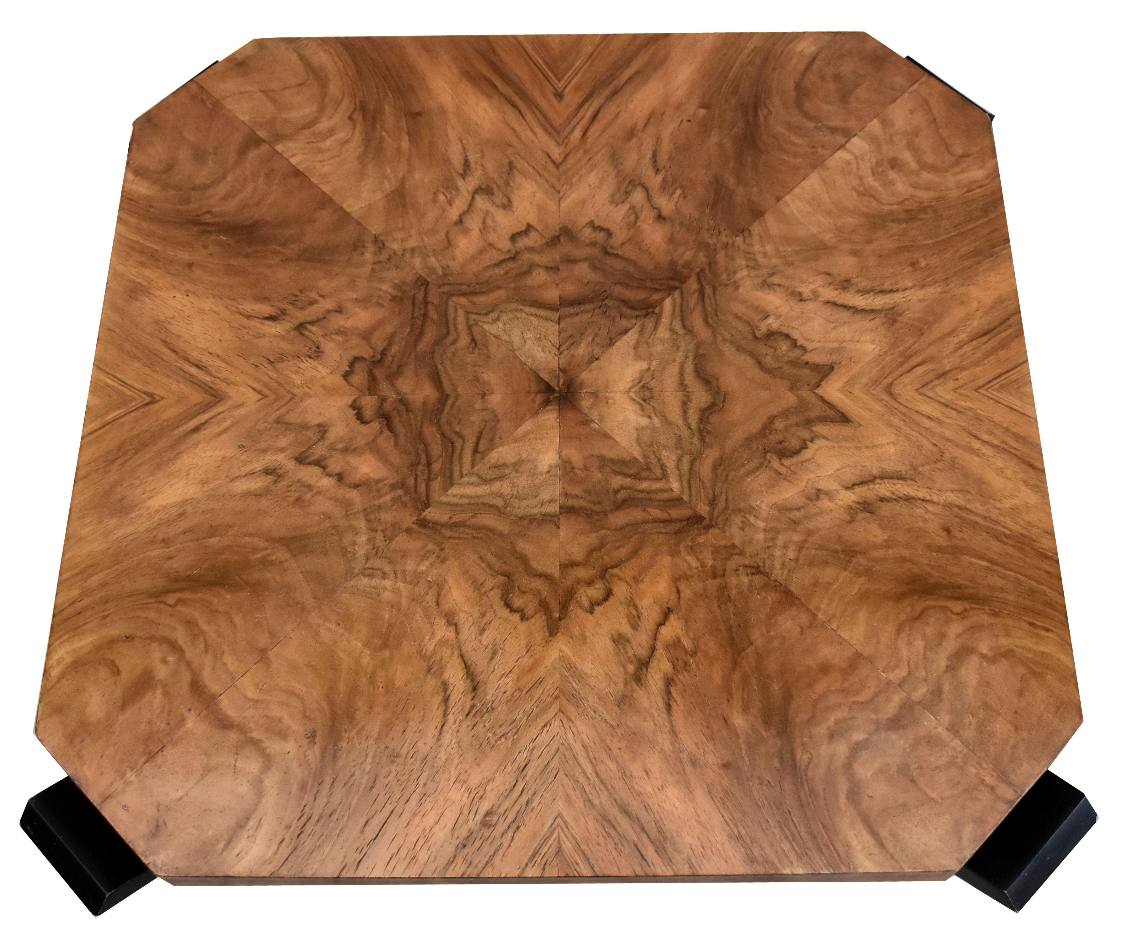 Very stylish Art Deco walnut table with ebonised legs creating a wonderful tulip shape and dating to the 1930's. This table is beautifully shaped and fully restored to showroom condition. Wonderfully figured walnut veneers to the top and base with