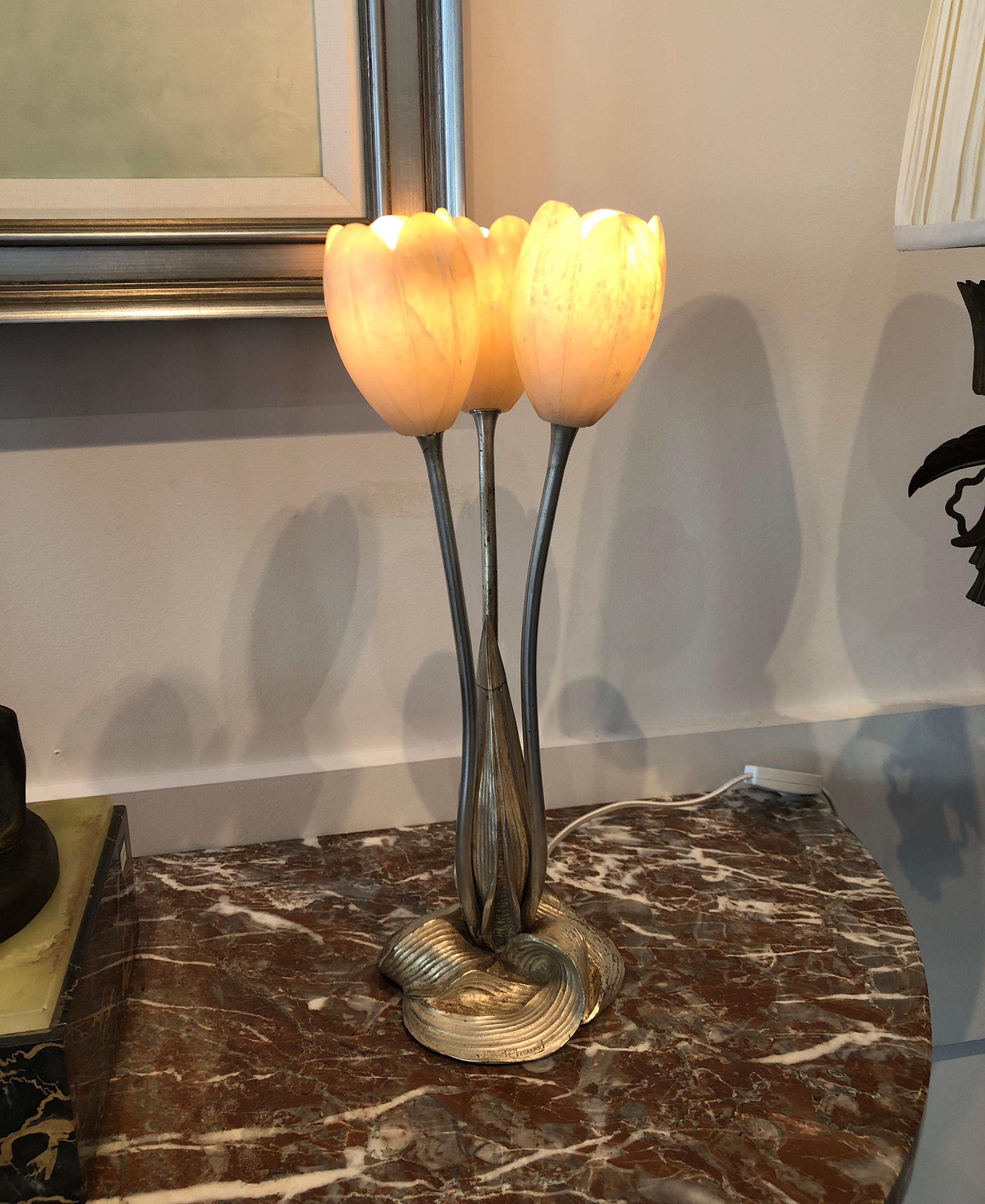 A beautiful Art Deco table lamp by the master artist Albert Cheuret, depicting three tulips flowers made on silver plated cast bronze with illuminated alabaster shades.

Made in France,
circa: 1925 
Signature: Albert Cheuret.