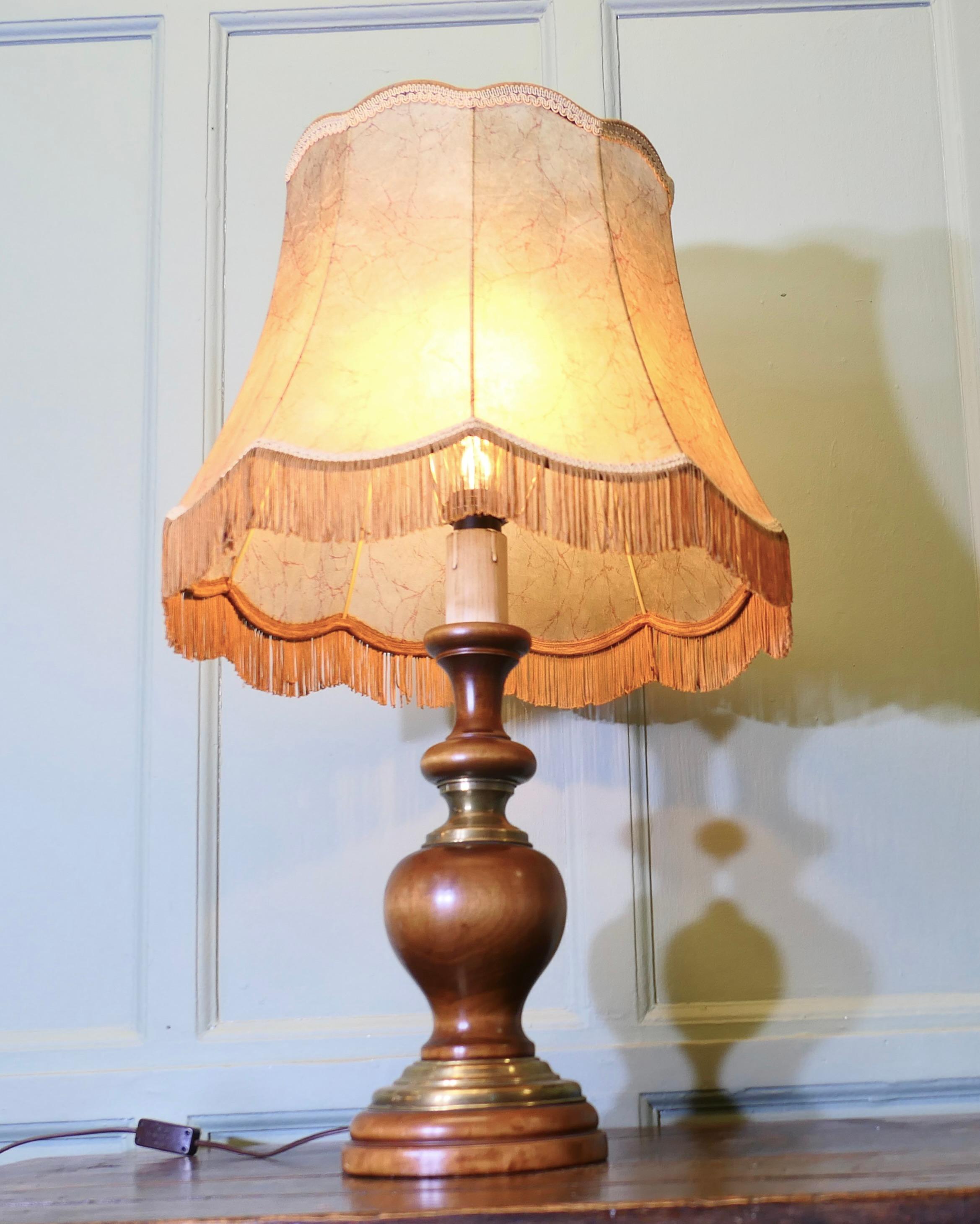 
Art Deco Turned Walnut and Brass Table Lamp 


The lamp has a beautifully turned walnut base with brass collars, it comes with its original pigskin fringed lampshade
The wiring is new, the lamp and shade are in good used condition
The Lamp is 32”