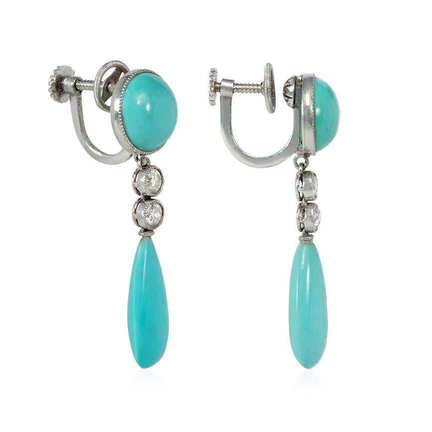 A pair of Art Deco earrings comprised of turquoise drop pendants suspended by two diamonds from a circular turquoise top, in platinum.  Atw 0.32 ct. diamonds