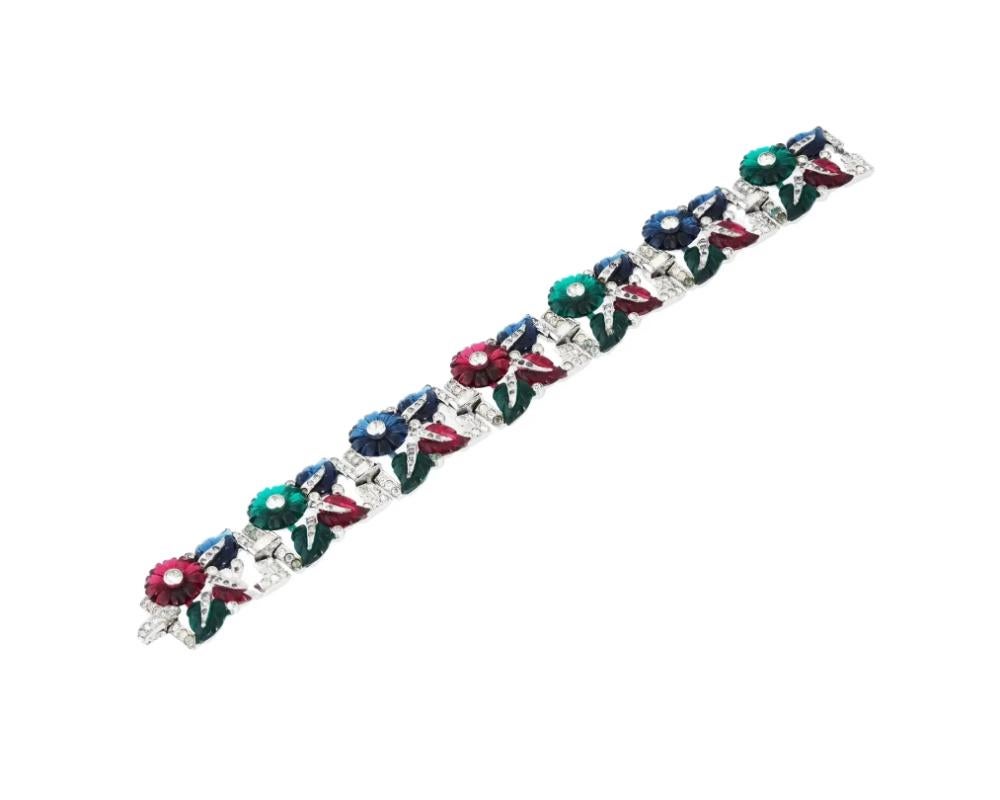 A vintage Alfred Philippe Art Deco tutti frutti bracelet adorned with intricate floral and foliage designs.

Colored Glass and Rhinestones

Art Deco style adds a touch of timeless sophistication. Circa the late 1920s. Vintage Art Deco Bracelets And