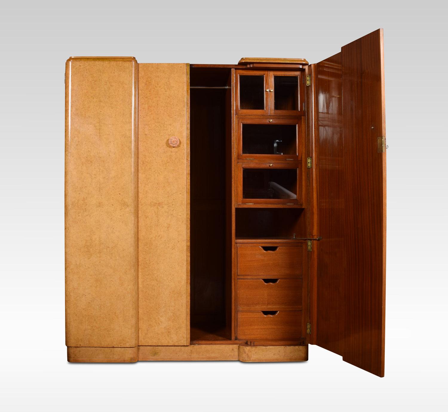 Large burr walnut Art Deco wardrobe, the two doors with Bakelite handles, opening to reveal fitted glazed compartments, drawers and hanging space. All raised up on plinth base (attributed to Harry and Lou Epstein
Dimensions:
Height 73.5 inches
Width
