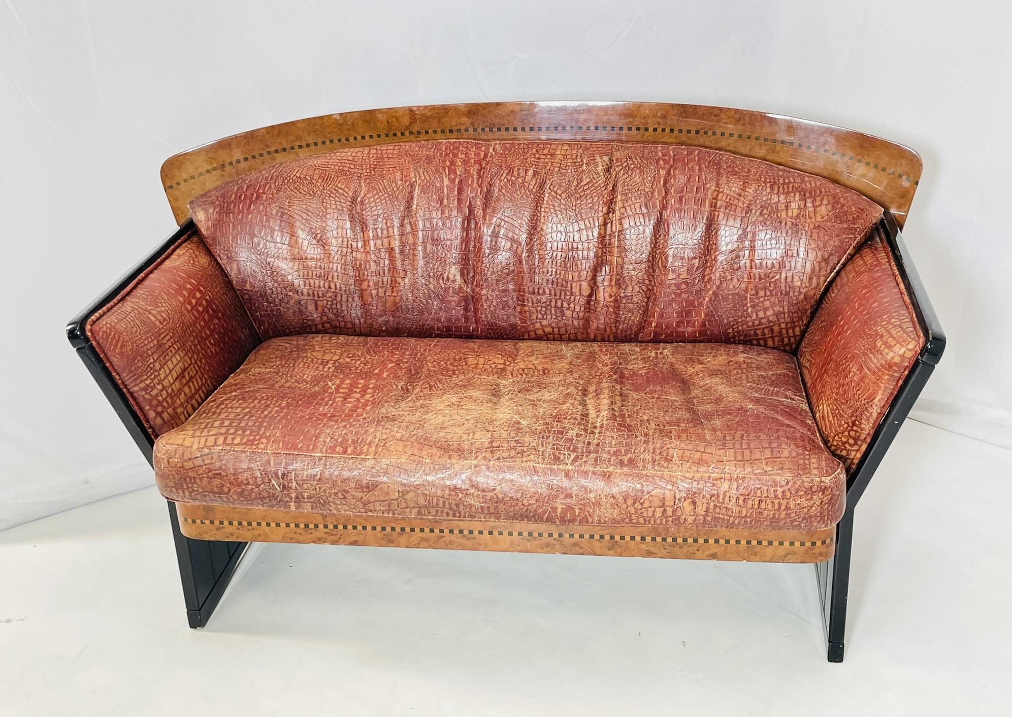 Introducing the exquisite Art Deco 2 seater sofa in Burlwood & Leather, originating from France in the 1940s. This stunning piece features a rich burlwood frame with sleek, curved arms and legs, exuding elegance and sophistication. The brown leather