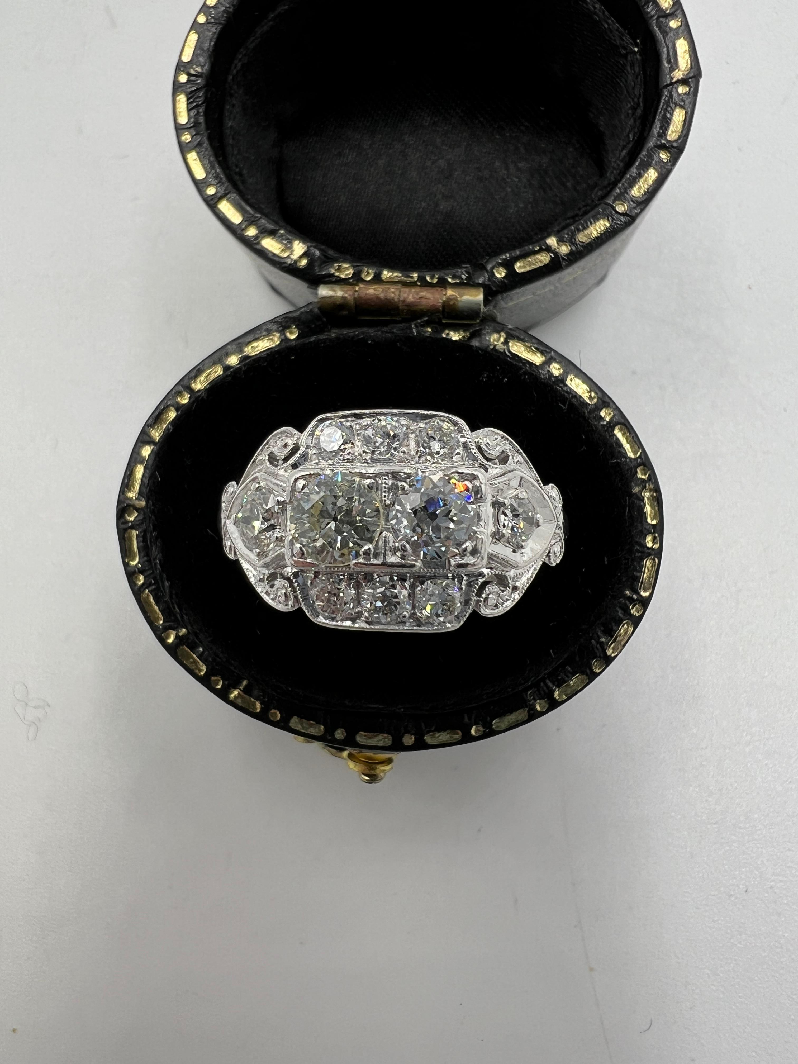 Art Deco two-stone diamond platinum ring, circa 1930s.

  A beautiful and unusual Art Deco two-stone diamond platinum ring.  First off the two center diamonds are slightly different in size and one has a warmer tone of color than the other.  Also,