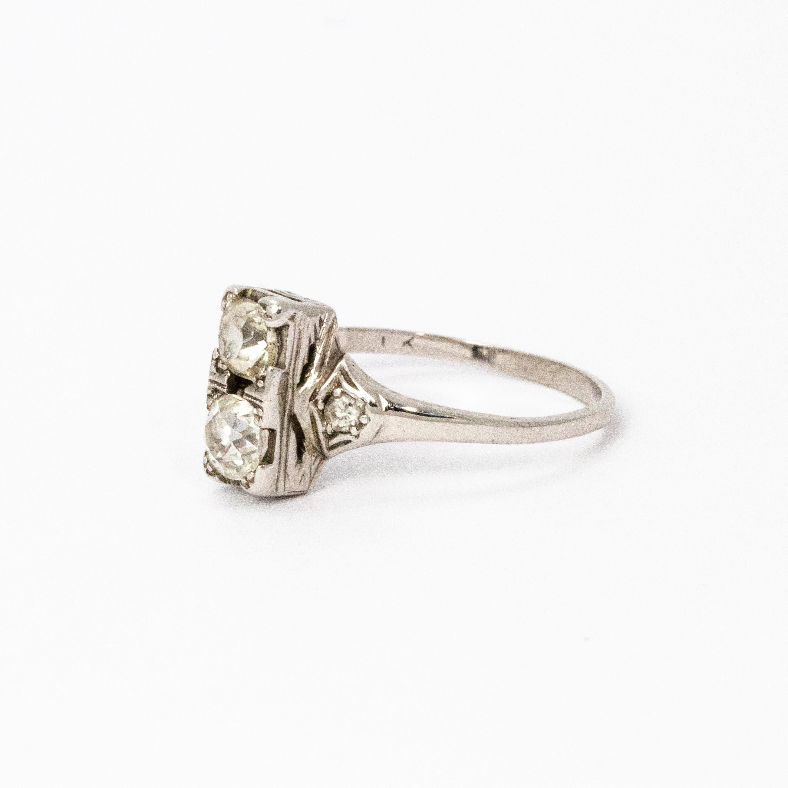 A beautiful Art Deco two-stone ring. Centrally set, one above the other, are two stunning old European cut diamonds measuring 30 points each. The shoulders are also set with diamonds. Modelled in platinum.

Ring Size: M or 6.5