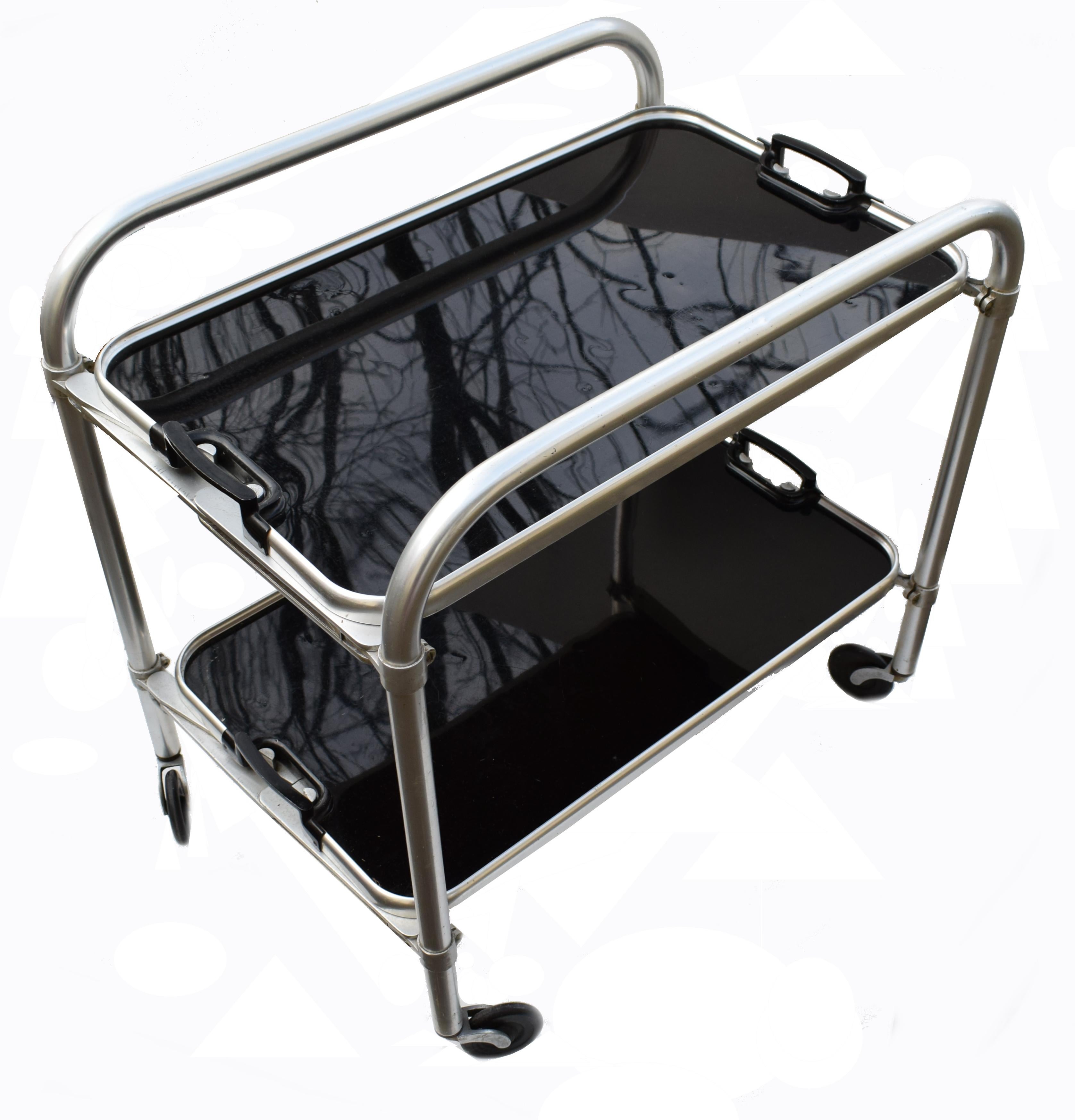 Stylish English two-tier Art Deco aluminium and drinks hostess trolley bar cart. Dating to the 1930s and If glam is your thing then this is for you! In situ these carts look nothing less than superb. Can be used for serving or just displaying your
