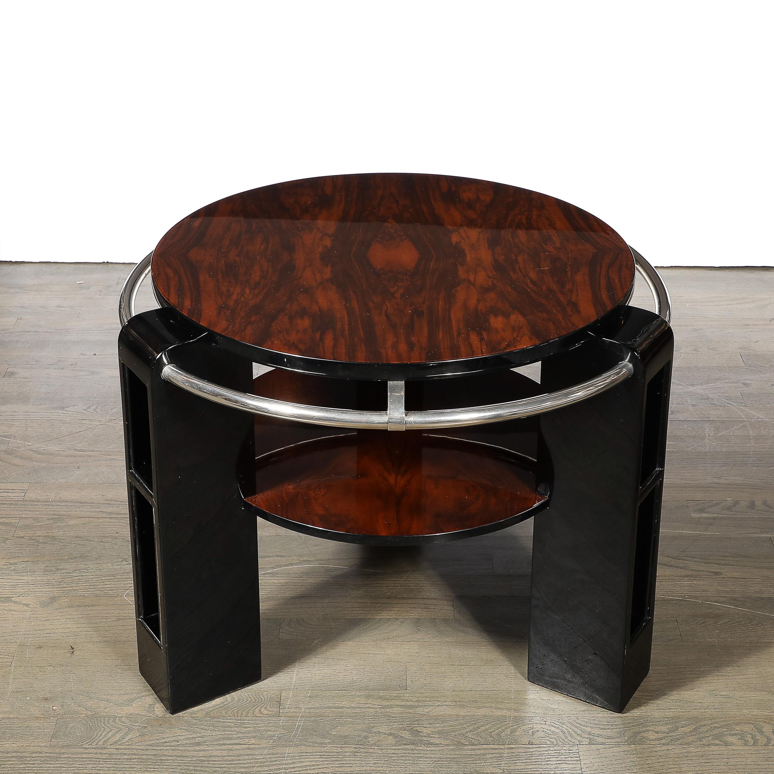 This bold and unique Art Deco Two-Tier Occasional Table W/Chrome Rail Detailing & Shelved Supports in Book-matched Walnut and Black Lacquer originates from France, Circa 1930. Features three supports finished in gleaming black lacquer with