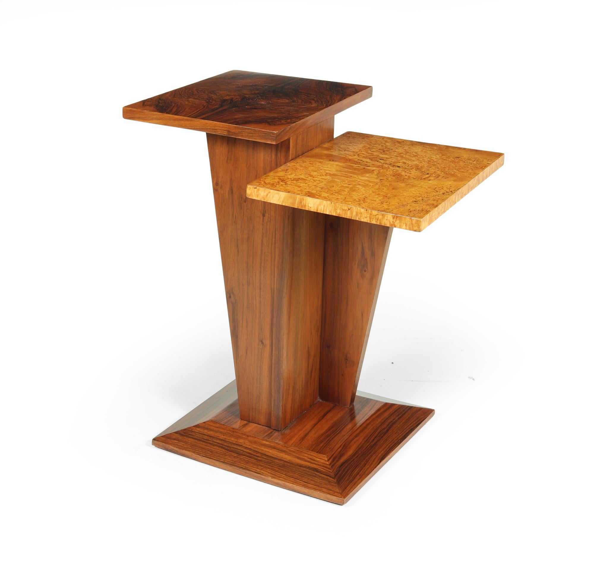 A very unusual French Art deco occasional table with two different height tops one in karelian birch and one in figured walnut on an angled center upright the table has been fully polished and is in excellent condition

Age: 1930

Style: Art