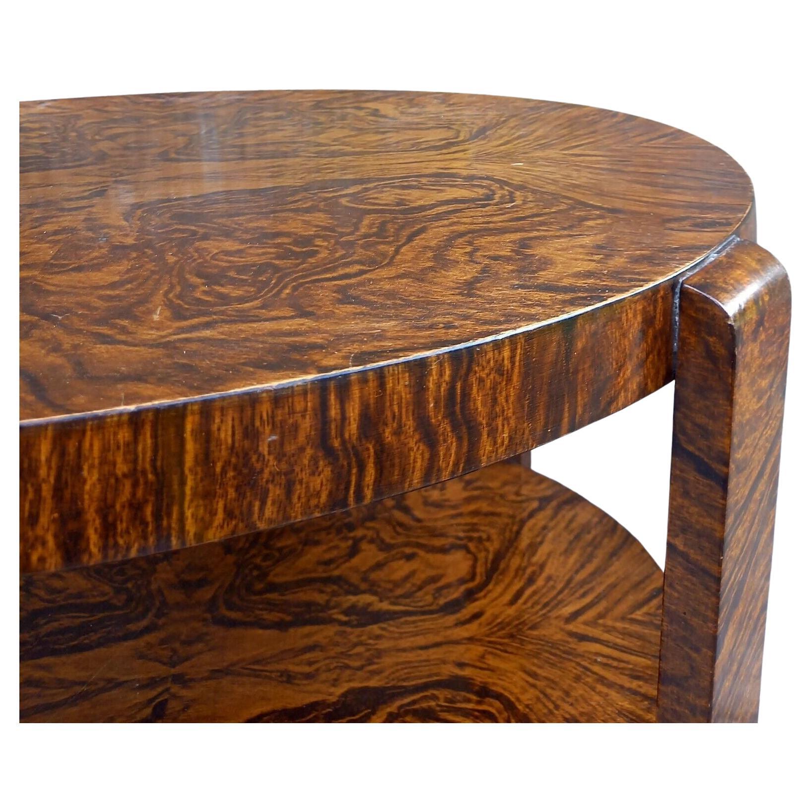 Très élégante table d'appoint ovale Art Déco anglaise à deux niveaux datant des années 1930. Un très bel exemple qui peut être utilisé à des fins multiples, un centre, un bout, une table basse. Une qualité fabuleuse avec des placages simulés figurés