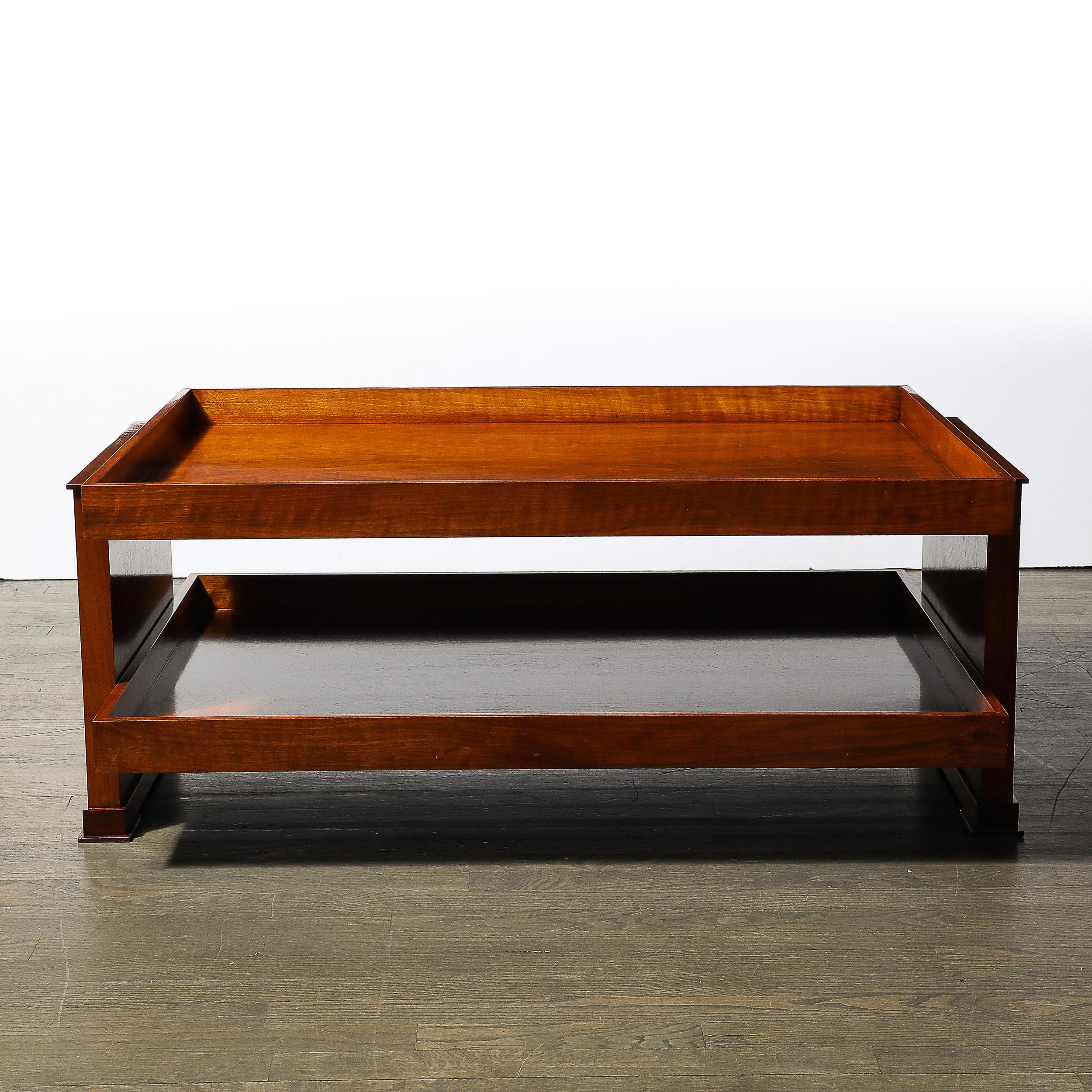 This beautifully proportioned Art Deco Two-Tier Rectilinear Cocktail Table in Book-matched Walnut W/ Raised Border originates from the United States during the 20th Century. The table boasts a practical two-tier design, offering ample surface space