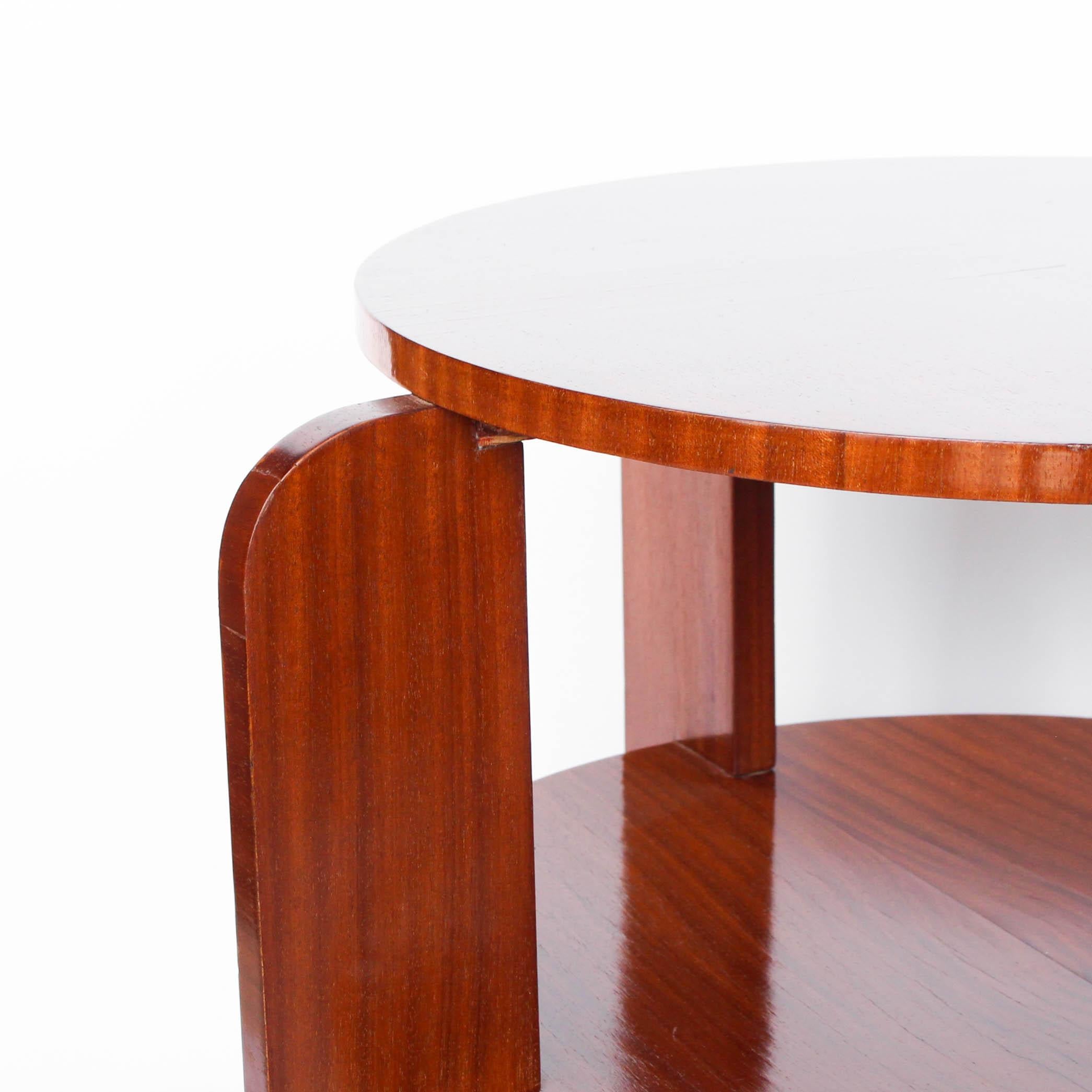 Round, two-tiered solid pine centre/coffee table with striped mahogany veneer.
  