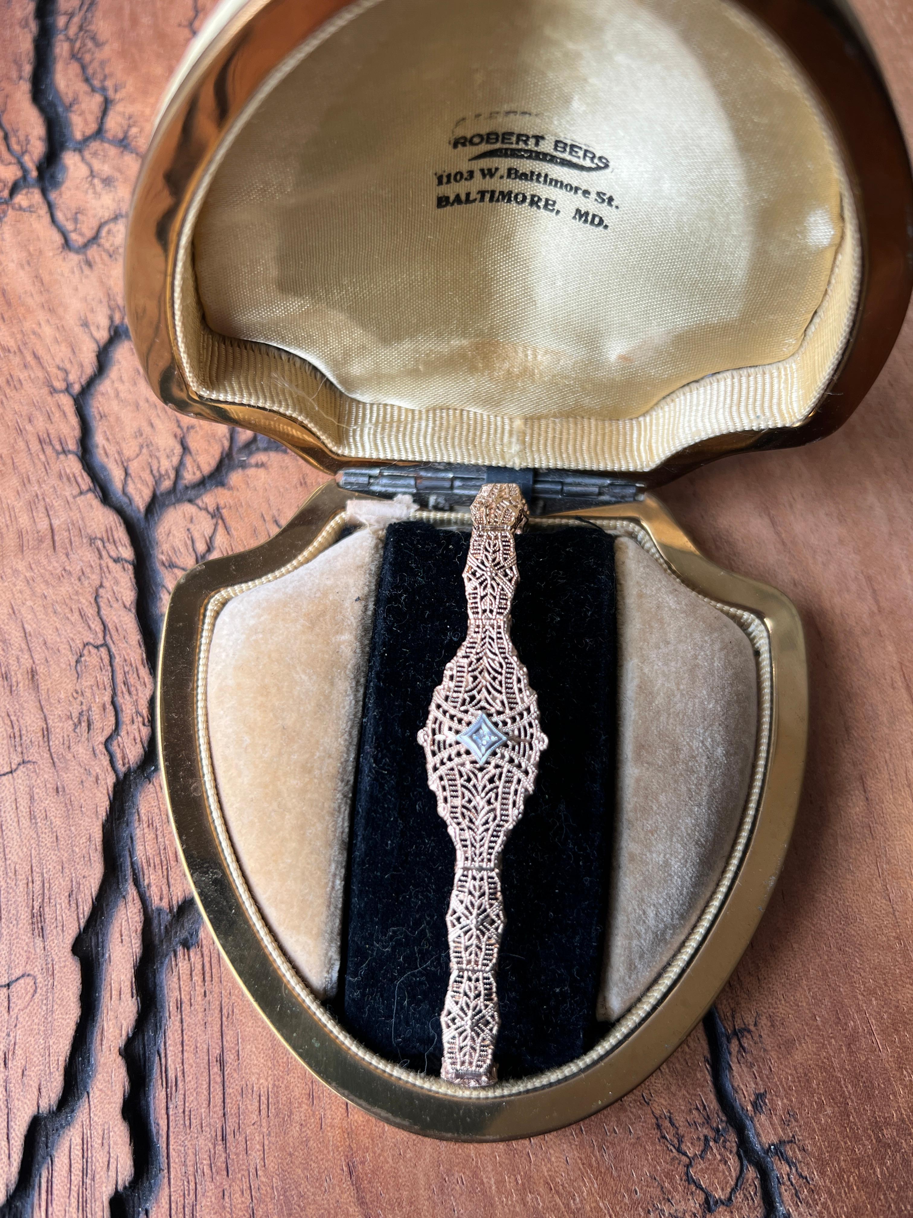 This remarkable two-tone gold and diamond bracelet captures the sophisticated spirit of the 1930s Art Deco movement with its intricate geometric openwork design. Crafted in 10 karat yellow and white gold, the piece showcases the era's distinctive