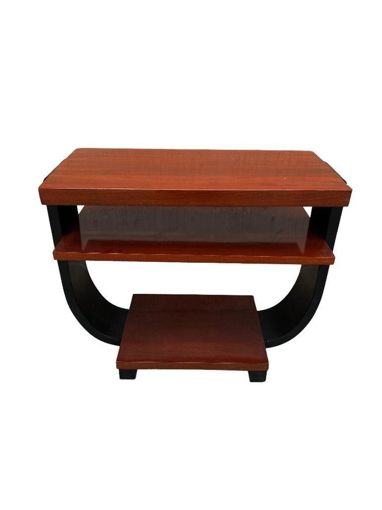Two-tone, two-tier Art Deco side table made of Pearwood. Fantastic side profile with a great geometric round Cantaleviered Stacking table, and curio display for any small decorative items. The table was designed by Gilbert Rohde for Brown Saltman