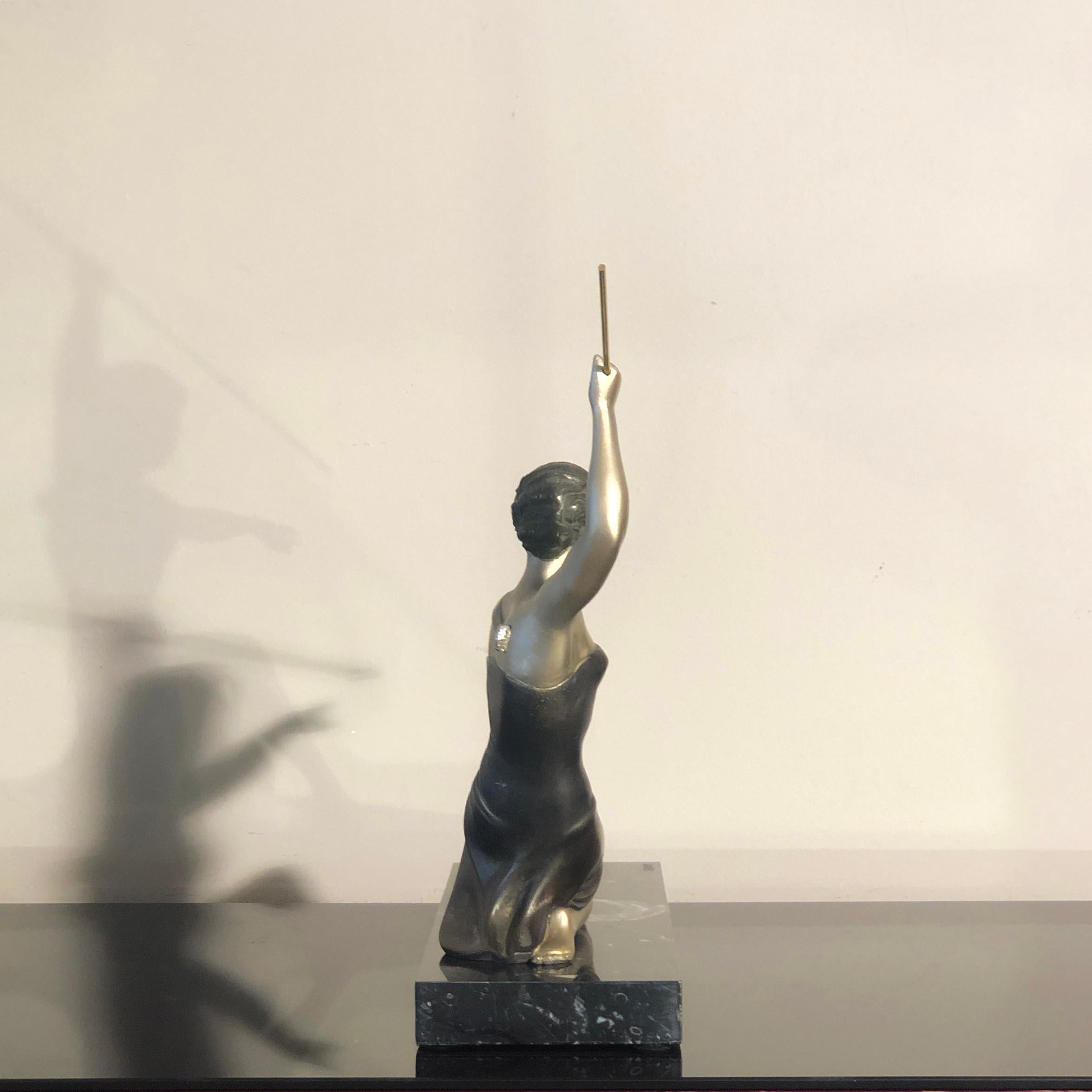 Diana the Huntress represented in this sculpture made and signed by Uriano (Ugo Cipriani) an Italian artist active in France during the Art Deco period (1930s). The sculpture is made in bronze on a marble base. The bronze is lacquered in different