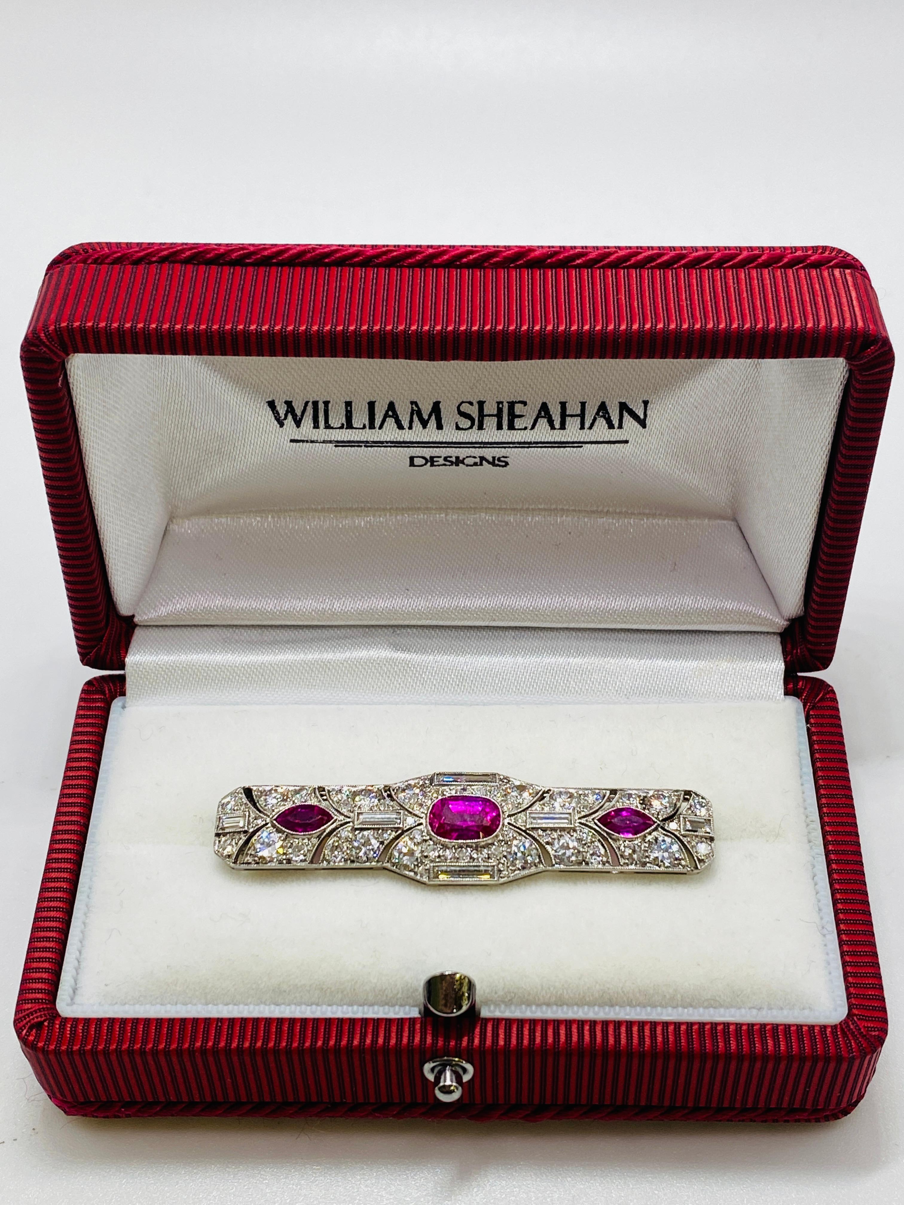 Art Deco Brooch with one 1.32ct Cushion-Cut Unheated Burmese Red Ruby, 2=0.68tw Marquise Cut Red Rubies, 6=0.56tw Baguette Diamonds, 54=2.04tw Old European Cut Diamonds. AGL report available for center 1.32ct unheated Burmese ruby. 