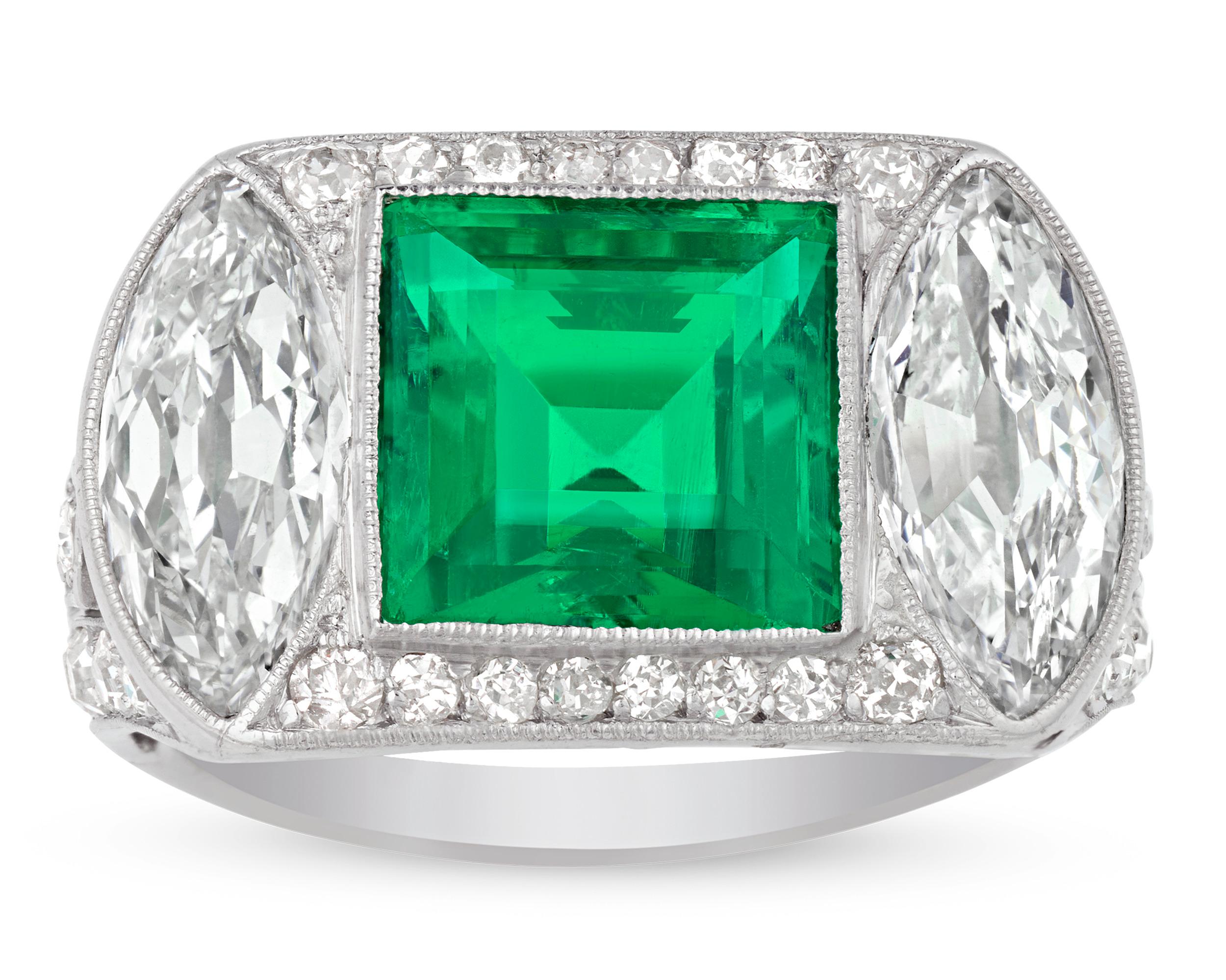 Art Deco-era elegance is reflected in this captivating emerald and diamond ring. The 2.89-carat emerald is certified by the American Gemological Laboratories as originating in Colombia and being completely free of oil and other treatments to enhance