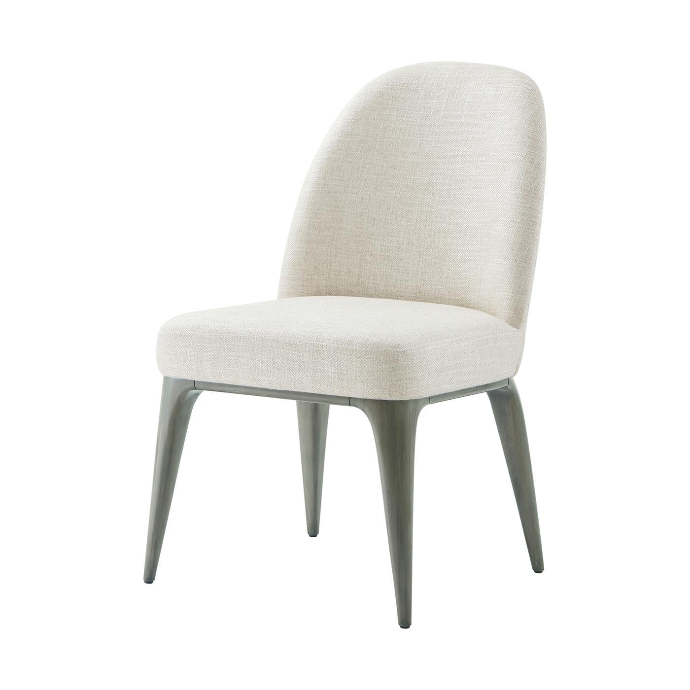 This sophisticated piece features a graceful design that combines comfort and style, perfect for any modern or classic interior. The chair is upholstered in a luxurious fabric that provides a soft and inviting seating experience, while its Pebble