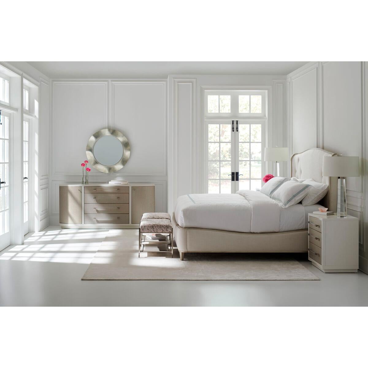 Flowing lines and gentle curves make this upholstered bed complementary to many styles, while having an influential presence of its own.
Button-pull details and an exposed wood frame in Silver Charm paint accentuate the headboard’s slight wing